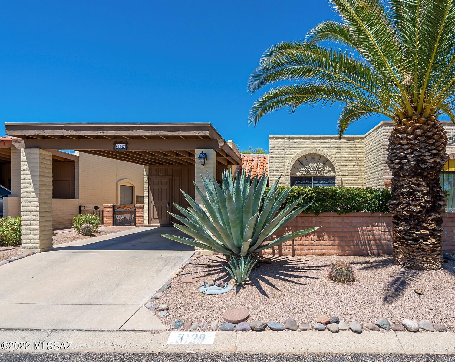 A large agave plant and a gorgeous palm tree give this home nice curb appeal.  This bright and cheerful townhouse is located in Desert Hills 3 and has a great location near several recreation centers.  The kitchen has twin skylights that let wonderful natural light into the room and has plenty of space for a table.  A large living room will give you various ways for furniture placement.  You will find tile floors in the kitchen and easy-care laminate flooring in the living room and bedrooms so cleaning will be a breeze.  The interior has just been completely painted so it is ready for you to move right it!  The north facing patio will keep you cool all year round and you'll appreciate the large mesquite tree hovering over the back patio.  Year round or your winter hide-away-  you just found it!