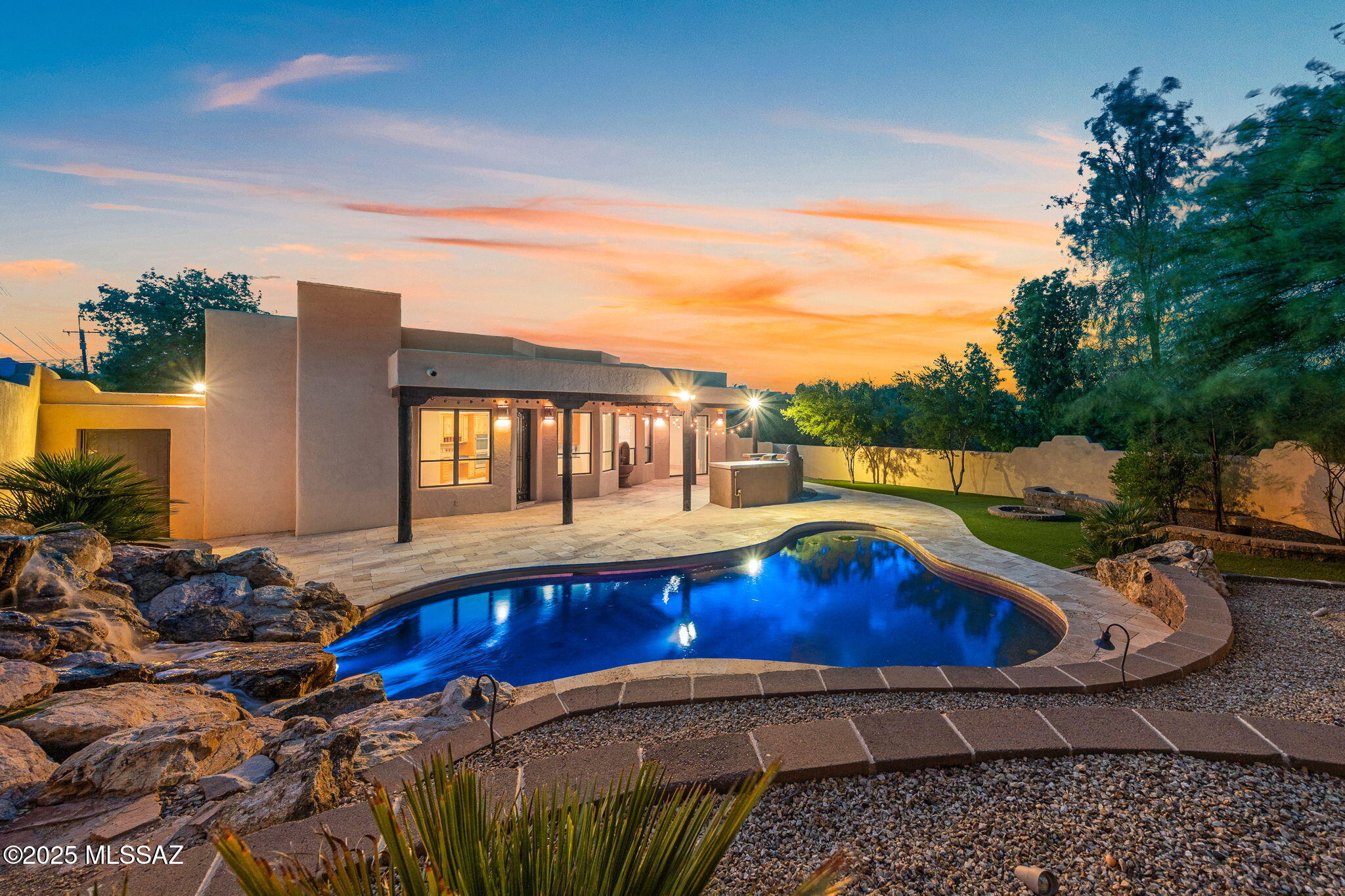 Nestled at the base of the Tucson Mountains, this home with two lots offers over an acre of privacy or resale potential. Enjoy mountain and city views, no HOA, and quick access to downtown and Starr Pass. Features include guest quarters with private entry and full en-suite, saltwater pool with travertine surround, rock waterfall, outdoor kitchen, and oversized garage. Rastra block construction and Rhino Shield full exterior paint offer energy efficiency and protect the longevity of this desert home oasis. Recent updates include: 2 newer HVAC units, new pool equipment, and roof recoating. Enjoy quality finishes throughout this home, from gourmet kitchen to vaulted foyer and gated courtyard. Seller is offering $15,000 toward rate buydown or closing costs - buyer's choice!
