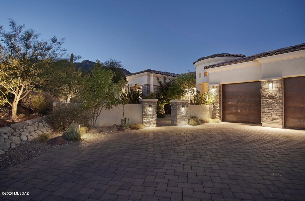 One of the best lots in Ventana Canyon. The 3841 sq.ft., split floor plan features 4BR/4BAs, Office w/built-ins, Great room, Family Room and Chef's kitchen. The stunning glass wall of windows seamlessly meld the indoor/outdoor space & accentuates the exquisite views.  Beautifully landscaped outdoor space has pool/spa & water feature, meandering gas fire pit, awesome outdoor kitchen, covered patio, and gate opening to the golf course.  Kitchen w/granite counters, center-island, SS appliances, gas cooktop, double oven, convection microwave, 2 dishwashers opens to expansive casual dining area and family room.   Private master suite has a stunning tile FP and spa-like bath w/tile shower, jetted bath, and 2 custom closets. Guest wing has 3 spacious BR's & 2BAs.  No expense spared!