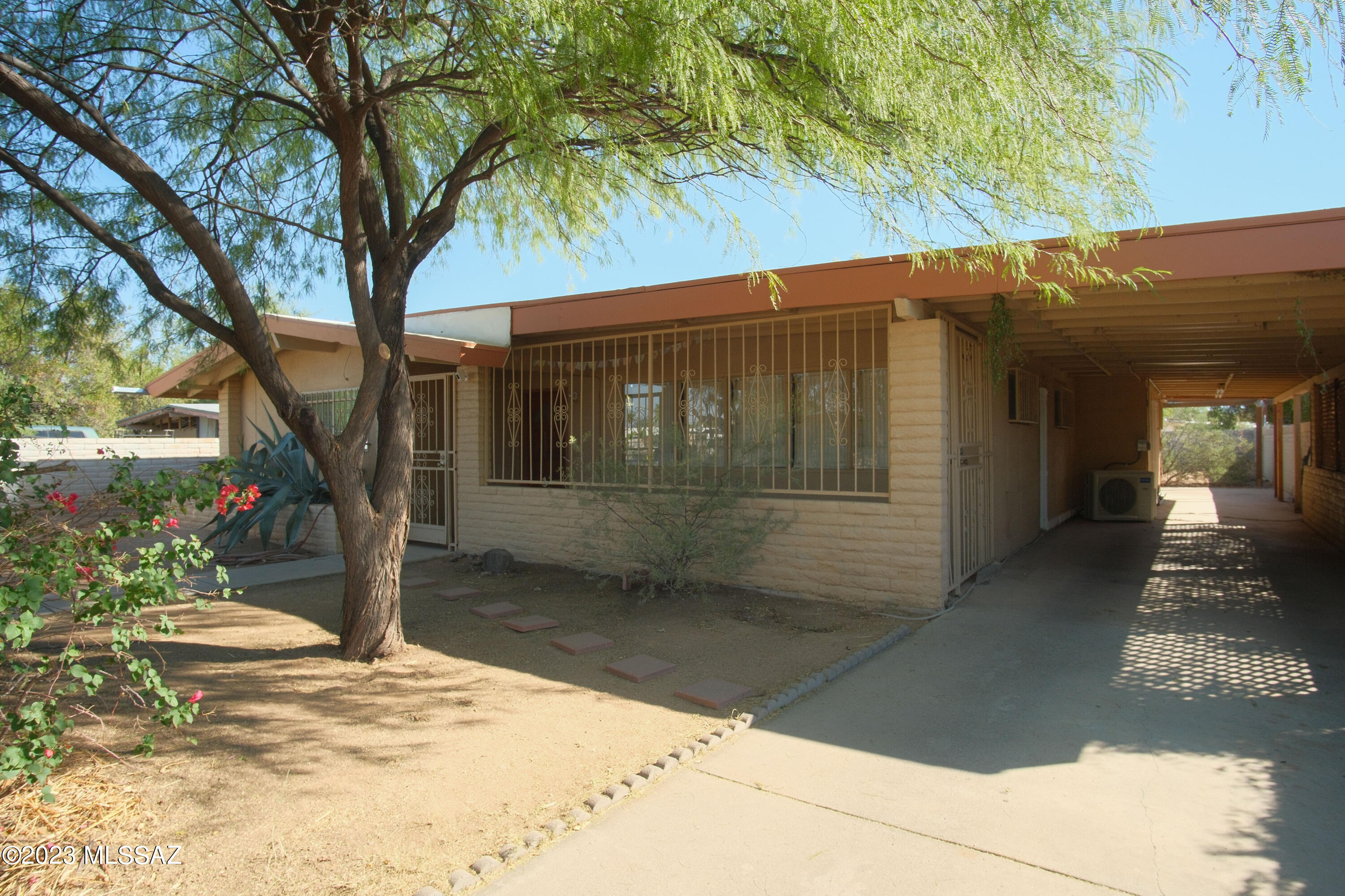 Wonderful opportunity to own a spacious home 10 minutes from The U of A, downtown, new and developing marketplace shopping area. This 4 bed, 2 bath home features spacious front and back yards shaded by mature, low-maintenance trees. Split bedroom concept, with primary bedroom off of family room.  Primary bedroom has its own exit to the back yard and its own full bathroom. Exposed beams in the living room and primary bedroom beautifies the space. Saltillo tile in the eat in nook and kitchen add rustic charm, while energy efficient solatubes add warm, natural light. Mini split systems and dual pane windows recently installed, making the home energy efficient. Within walking distance from the neighborhood park and two planned bicycle boulevards, this home was enjoyed by the same family for almost 20 years with many upgrades made over that time!