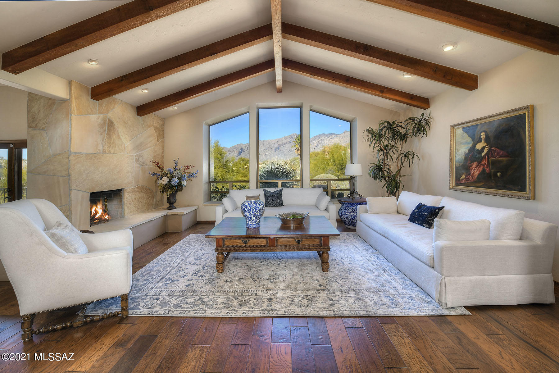 Stunning soft contemporary w/magnificent mountain views on 1.4 acres in prestigious gated Catalina Foothills Est.#10. Front gated flagstone courtyd w/fountain, foyer entry, exquisite living rm w/high vaulted ceilings, dramatic flagstone fireplace, cozy sitting area, walls of windows, gorgeous wood plank flrs, formal dining rm, remodeled gourmet island kit w/knotty alder cabinets, granite countertops,designer tile backsplash, breakfast area, beautiful porcelain tile flrs, 2 BR's + lg den w/ fireplace (or 3rd bedroom), 3 BA's (master BR w/wood flrs, lux bath w/dble sinks, tub, separate shower, walk in closet & entry to rear patio). Enjoy outdoor living w/2 cov'd patios, lush landscaping, fruit trees, oversized 2 car garage, circular brick paver driveway, Dist.16 schools & majestic mtn views