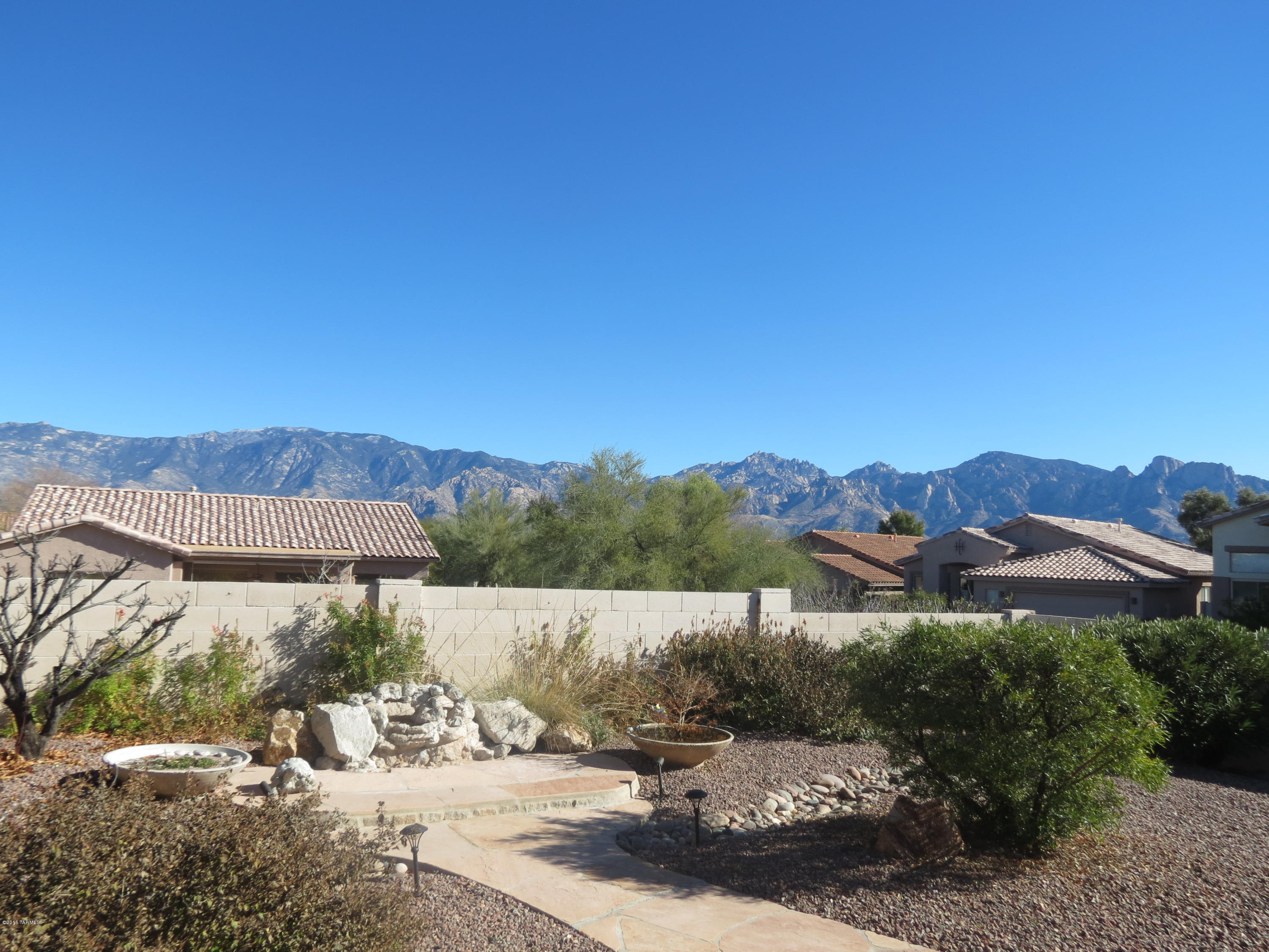 Mountain Views!! Very clean home. Show your fussiest buyers. Extra large den can be third bedroom. Open great room.  Beautiful new tile floors. New interior/exterior paint. Furniture in home is negotiable. Two small antique gold chairs in guest bedroom do not convey.