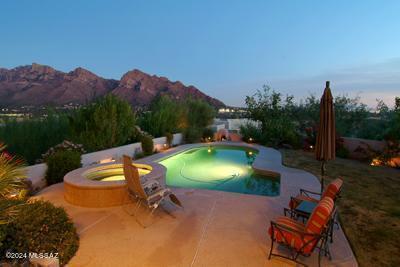 Welcome to this impeccably designed home, nestled in the heart of Oro Valley. Boasting a perfect blend of contemporary elegance and timeless charm, this residence offers the ultimate in lifestyle living. As you step inside, you are greeted by a spacious open floor plan, adorned with high ceilings and an abundance of natural light, creating an inviting ambiance throughout. The gourmet kitchen is a culinary enthusiast's dream, equipped with stainless steel appliances, granite countertops and ample storage space. Inside you will enjoy the split floor plan, travertine floors throughout and comfort for you and your guests.  Step outside to discover your own private oasis, where lush landscaping and a tranquil patio provide the perfect backdrop for the glorious mountain and city views. Convenient to all Oro Valley amenities.