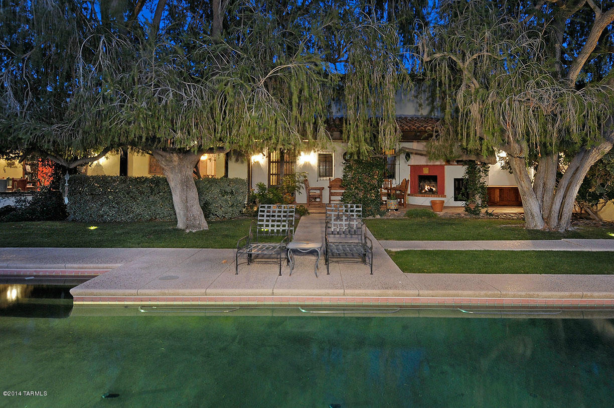 One of the finest Authentic Joesler homes built in the foothills. Old World charm and elegance with massive rooms, original red concrete floors, carved beam ceilings, wine cellar, guest quarters, end of the road, truly a private estate. Beautiful gardens with 60 year old bottlebrush trees, Spanish Portico, fountains, pool and views in every direction. Located on top of a ridge in The Catalina Foothills. Wonderful for entertaining inside and out.