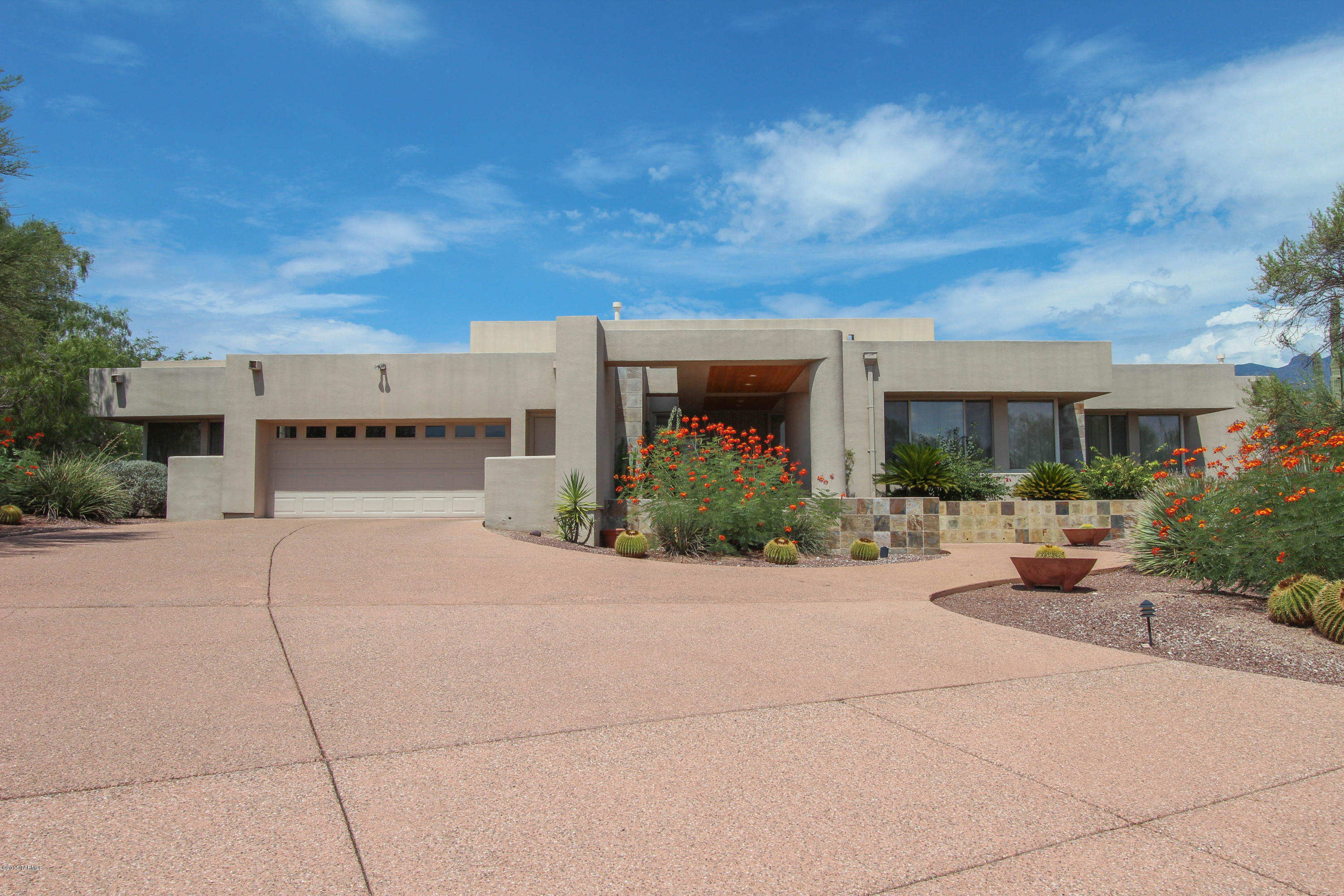 Designed by Robinette Architects,this wonderful home with Seller customization is located in the gated Ballas Catalinas Estates. One of a kind home features open floor plan with floor to ceiling windows across the entire back of the home offering an unobstructed view of the Catalina Mountains. Livingroom has it all,large beautiful built in bookshelf,custom storage areas & decorating nooks,gas fireplace,wood ceilings & custom window coverings. Gorgeous Kitchen,with large island,many cabinets,build in desk.  Truly a Master Suite, comfortable sitting area off the bedroom, dreamy walk in closet, jet bathtub,large walk in shower,private toilet & bidet. Home is airy, light and flows easily. 3 sliding doors open to back patio providing wonderful space for entertaining.