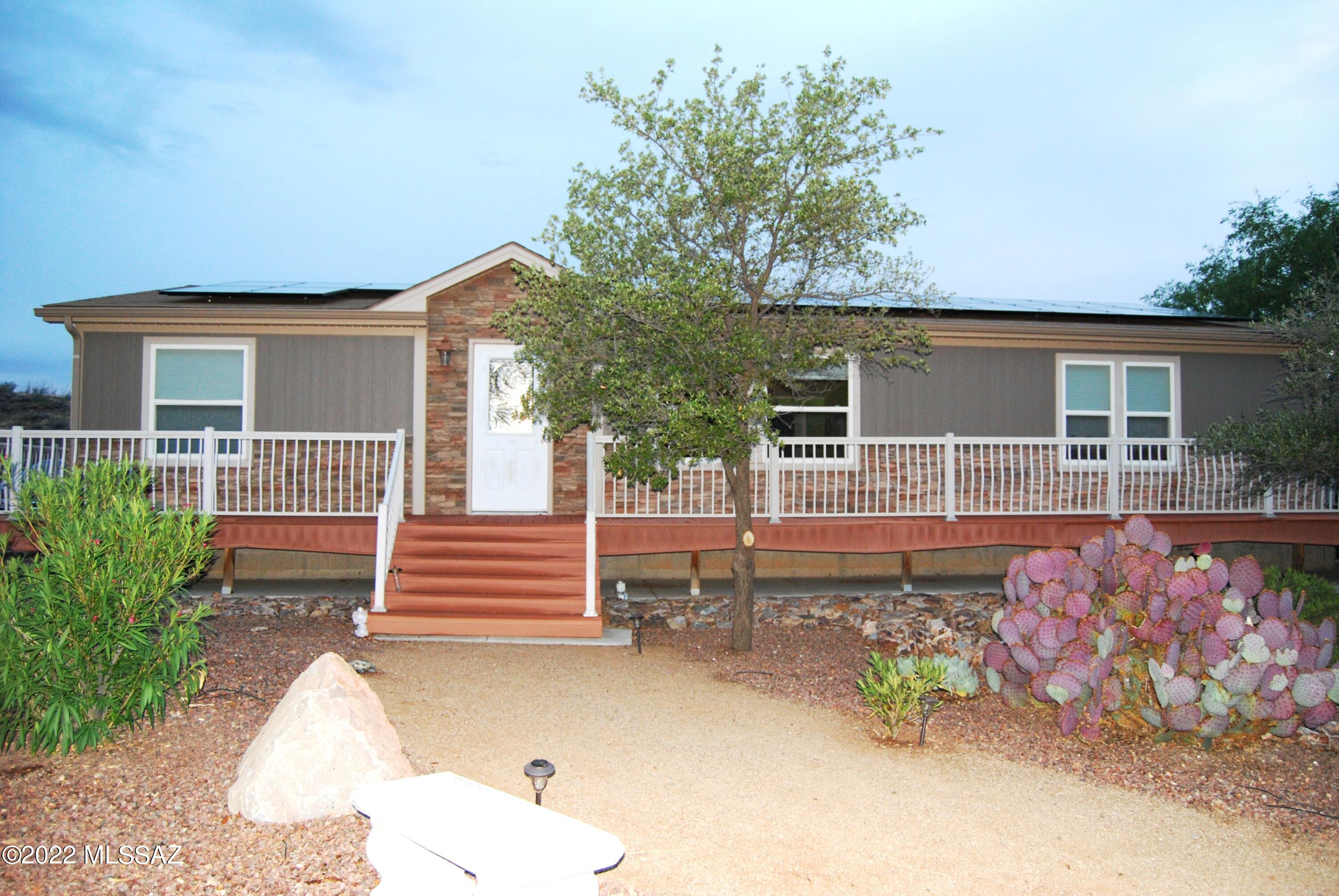 Beautiful Manufactured home on 5 acres, In the Vail school district. Gated property at the end of the road. 3 Bedrooms, 2 bath. Large master suite with updated bathroom and walk in closets. Open concept kitchen living and dinning . New flooring. Bonus room with built in bar. Solar panels.  Large detached 3 car garage, well maintained landscaping around house.  Gorgeous panoramic views of the mountains can be seen anywhere on the wrap around deck .