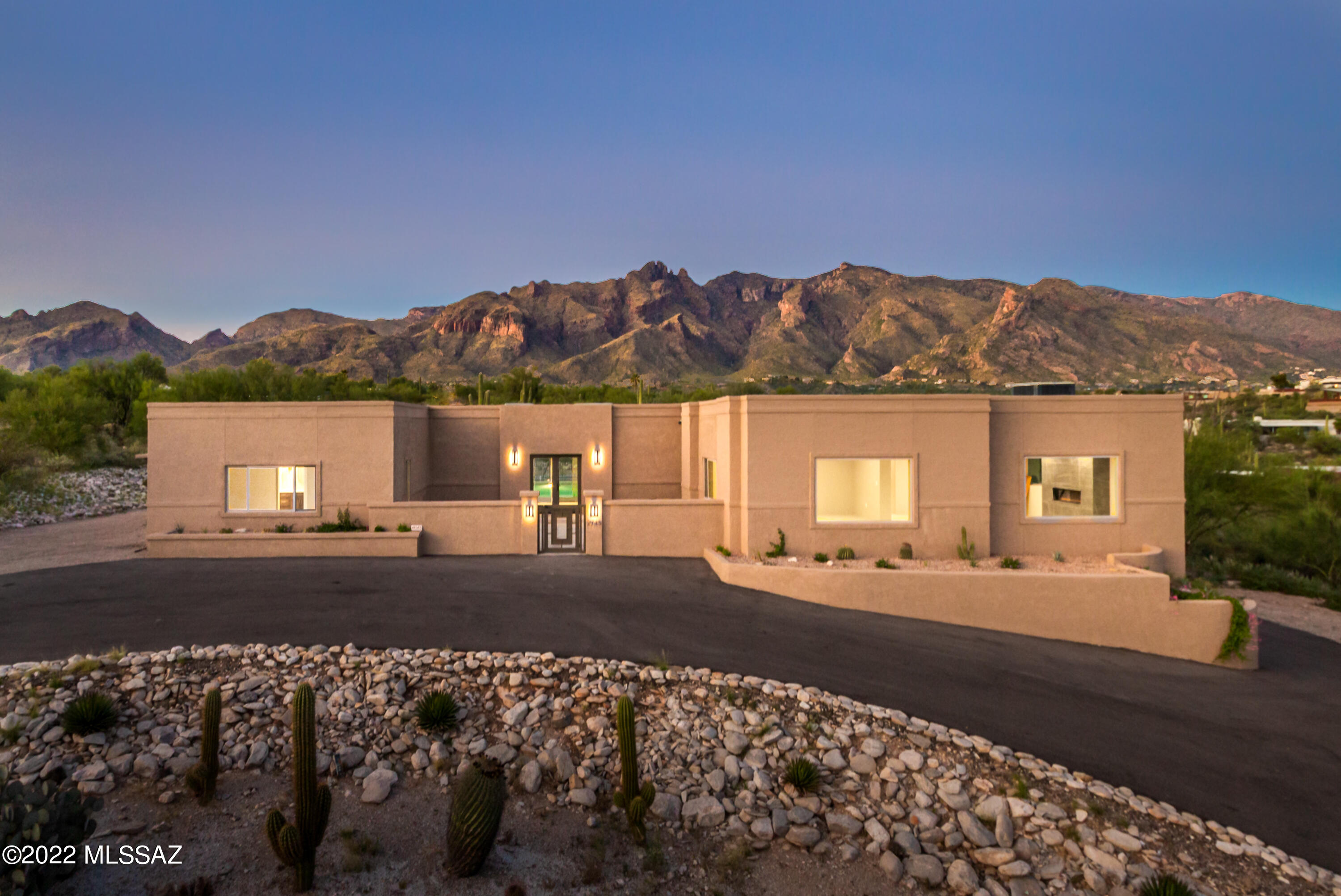 Built in 1973 but almost entirely re-built in 2022 this 3,964sf home has 3BR, 3½BA plus 1BR, 1BA guest quarters with separate entry on 1.2 acre foothills lot. Amazing views of the Catalina Mountains, Downtown Tucson City Lights & La Paloma Golf Course. Just a short drive or walk north to upscale shopping, galleries, restaurants or head south to downtown or UA's campus in a matter of minutes.  Professionally designed by award-winning Dorado Designs specializing in custom interior design & remodeling. All New kitchen, baths & porcelain tile flooring. Almost all new doors & windows, newer roof, new interior & exterior paint, new driveway. New upgraded foam insulation inside solid concrete block walls. Newer fiberglass insulation in ceilings, new drywall throughout. Kitchen has new stainless appliances, cabinetry, quartz counters & huge island. New fireplace in great room. New 400 AMP electrical service, new sub panel, distribution systems, wiring & fixtures. Exterior has new stucco, new underground lines to existing septic system. New water lines from meter to home & all new water pipes throughout the home. New front yard irrigation & landscaping. Newly renovated pool including all new plumbing, new Kool deck, new pump, filter & automated pool cover.