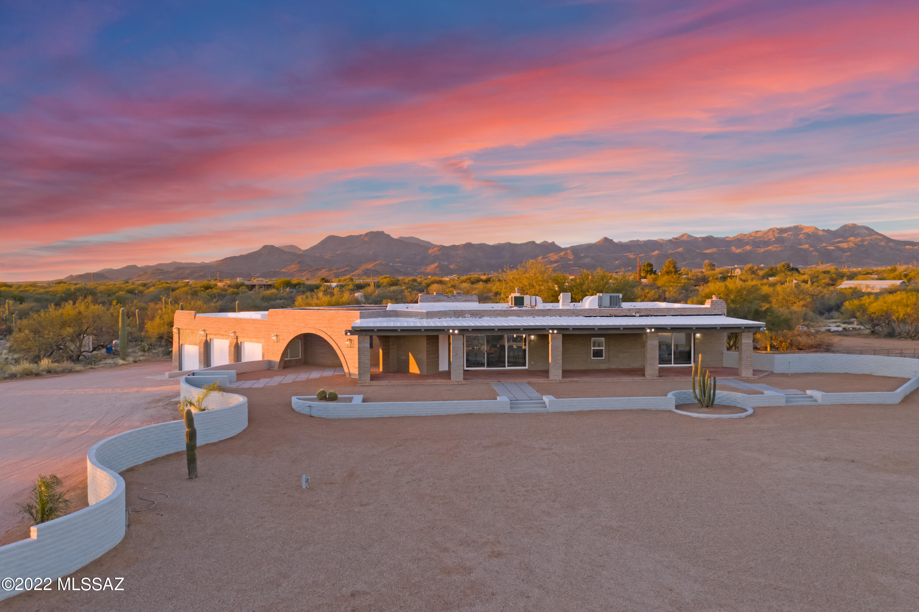 Stunningly upgraded Ranch style home on a huge 9.55 acre subdividable lot with no HOA! This home offers potential for a multi-generation living arrangement with 2 sprawling levels of living space. On the main level enjoy the bright and spacious great room, open to the gourmet chefs kitchen complete with top of the line appliances, new soft-close cabinets, quartz countertops, beverage cooler, breakfast bar, walk in pantry, and a 7-burner range with a pot filler! Relax in the enormous owner suite with a cozy fireplace, sitting room, freestanding tub, dual vanity, custom shower and private deck. Half bath conveniently located off the great room for guests. On the lower level there is a second huge owners suite with an additional 2 bedrooms and 2 full baths.  Large bonus area can be used as a game/media or living room. Additional space can be converted into a full kitchen and dining area if desired (plumbing and electrical are already available for conversion). Separate entrance from the exterior to the lower level makes it private and ideal for a split living arrangement. Heated and cooled 1,100 sqft 3 car garage with fresh epoxy floors (one bay could easily be converted for covered RV parking). The newly refinished pool overlooks the Tortolitas and beautiful natural desert. Enjoy the endless 360* mountain, sunrise and sunset views with plenty of viewing options from multiple decks and/or patios. Great NW location close to La Cholla Airpark, awesome schools, shopping, dining and outdoor recreation. No detail has been overlooked in the complete remodel, this unique home is better than new! Low maintenance landscaping, private well, additional slab/foundation available for a guest home, barn, basketball court, or whatever you can imagine! Plenty of room for horses, toys and all your hobbies!
