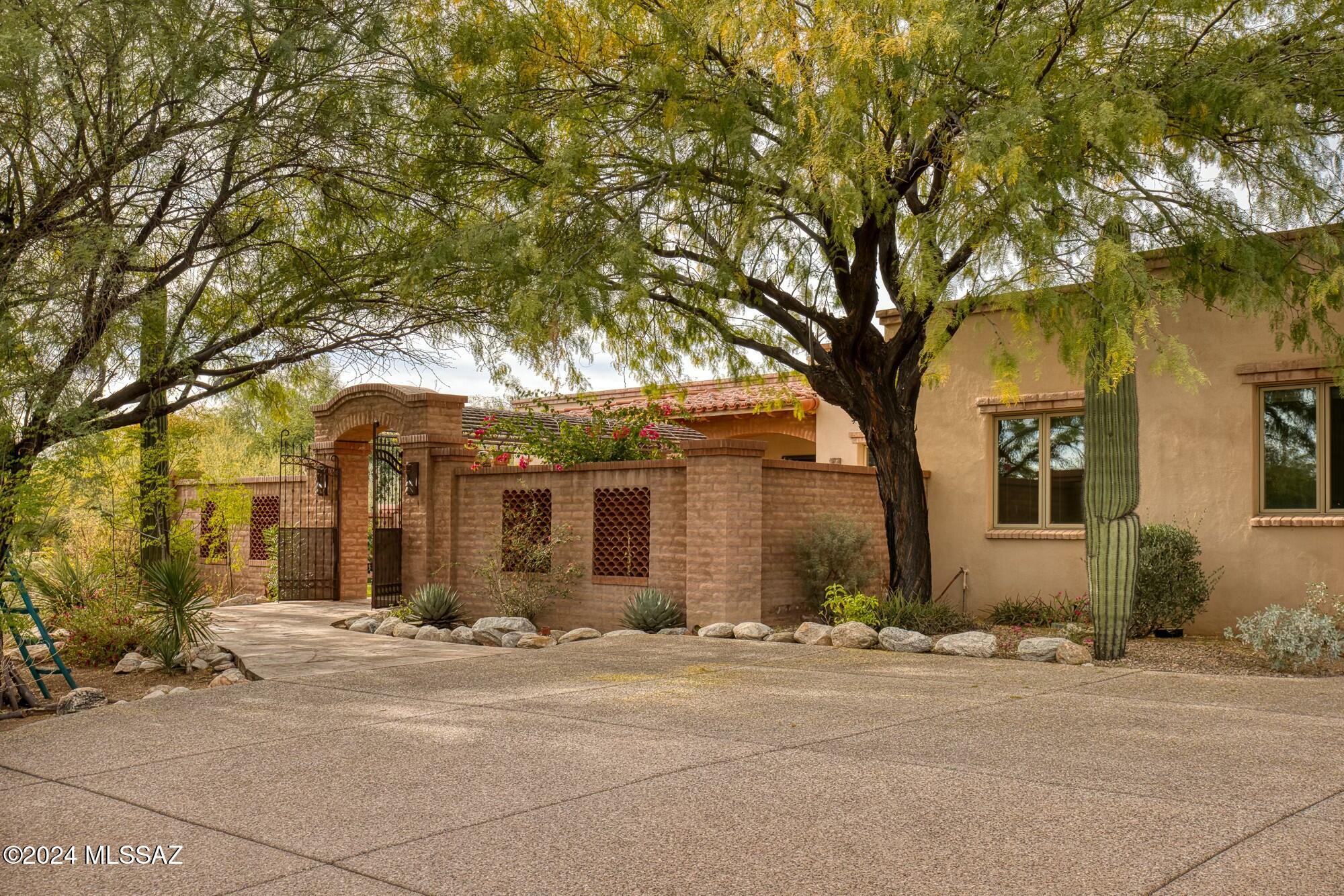 Experience the ultimate in luxury and location at 3174 E Via Palomita, a beautifully appointed property in the exclusive La Paloma Estates. Nestled in the breathtaking Catalina Foothills, this home offers an unparalleled blend of Southwest elegance and modern comfort, making it the perfect retreat in the Catalina Foothills. The single level 5 bedroom, 6 bathroom, 4,984 Sq Ft masonry home sits on over an acre lot with direct views of the Santa Catalina Mountains. Fantastic split bedroom open floor plan, featuring high ceilings, and large Pella windows that provide the home with an abundance of natural light. Privately situated and sizable primary bedroom with enormous dual closets and spa-like ensuite that has direct access to the backyard. With two additional ensuite bedrooms, combined with two more bedrooms with adjacent bathrooms, the home offers generous space yet private comfort & luxury. 

The kitchen, dining, and family room are well thought out for both entertainment and intimate family gatherings. Gourmet kitchen with granite countertops, cherry cabinets, high-end stainless-steel appliances, and ample storage space.

The backyard is surrounded by serene desert landscape, mountain views & features resort-style amenities that provide perfect relaxation & entertainment options: spa and pool, outdoor kitchen, fireplace, dining & entertainment space under the large 500 Sq Ft covered patio.

La Paloma Estates stands out as one of the most desirable neighborhoods in Tucson, offering a perfect combination of natural beauty, luxury living, and unparalleled convenience.

Prime Catalina Foothills Location
Nestled at the base of the breathtaking Catalina Mountains, La Paloma Estates provides stunning views of the desert landscape. Its elevated location offers a sense of tranquility while being just minutes from Tucson's best amenities, including La Encantada Mall, fine dining, and vibrant cultural attractions.

Exclusive, Gated Community
Security and privacy are paramount in La Paloma Estates. The gated entrance and beautifully maintained grounds create an atmosphere of exclusivity and peace of mind for residents.

Proximity to La Paloma Country Club
Home to the La Paloma Golf & Country Club, residents enjoy direct access to an award-winning Jack Nicklaus Signature golf course, tennis courts, a state-of-the-art fitness center, and resort-style pools. Membership offers a vibrant social calendar and opportunities to connect with neighbors.

Exceptional Schools
La Paloma is located within the Catalina Foothills School District, consistently ranked among the top in Arizona. Families benefit from access to some of the region's best educational institutions.

Natural Beauty and Outdoor Activities
The community is surrounded by the natural splendor of the Sonoran Desert. Hiking, biking, and exploring nearby trails like Finger Rock Trailhead or Sabino Canyon are favorite pastimes for residents.

Whether you're seeking a serene retreat or an entertainer's paradise, this home embodies the best of Tucson living in the Catalina Foothills and the La Paloma Lifestyle.