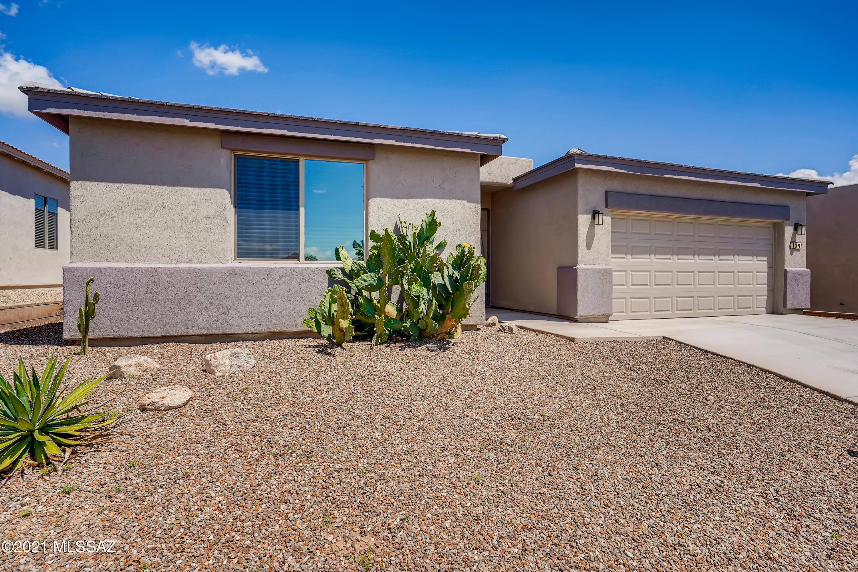 You will fall in love with this 3 bedroom, 2 bathroom open concept home that lets natural light settle in all the right places. Upon entry, admire the contemporary finishes complete with sleek flooring and vaulted ceilings. Prepare a delicious meal in the pristine kitchen that offers a breakfast bar, stainless steel appliances, granite countertops, and space to store all of your essentials in the pantry. The primary bedroom has access to the covered back patio outfitted with an en suite, including a dual sink vanity, a floor-to-ceiling tiled shower, and a spacious closet. This home provides a central location less than 5 minutes to dining and Green Valley shopping.