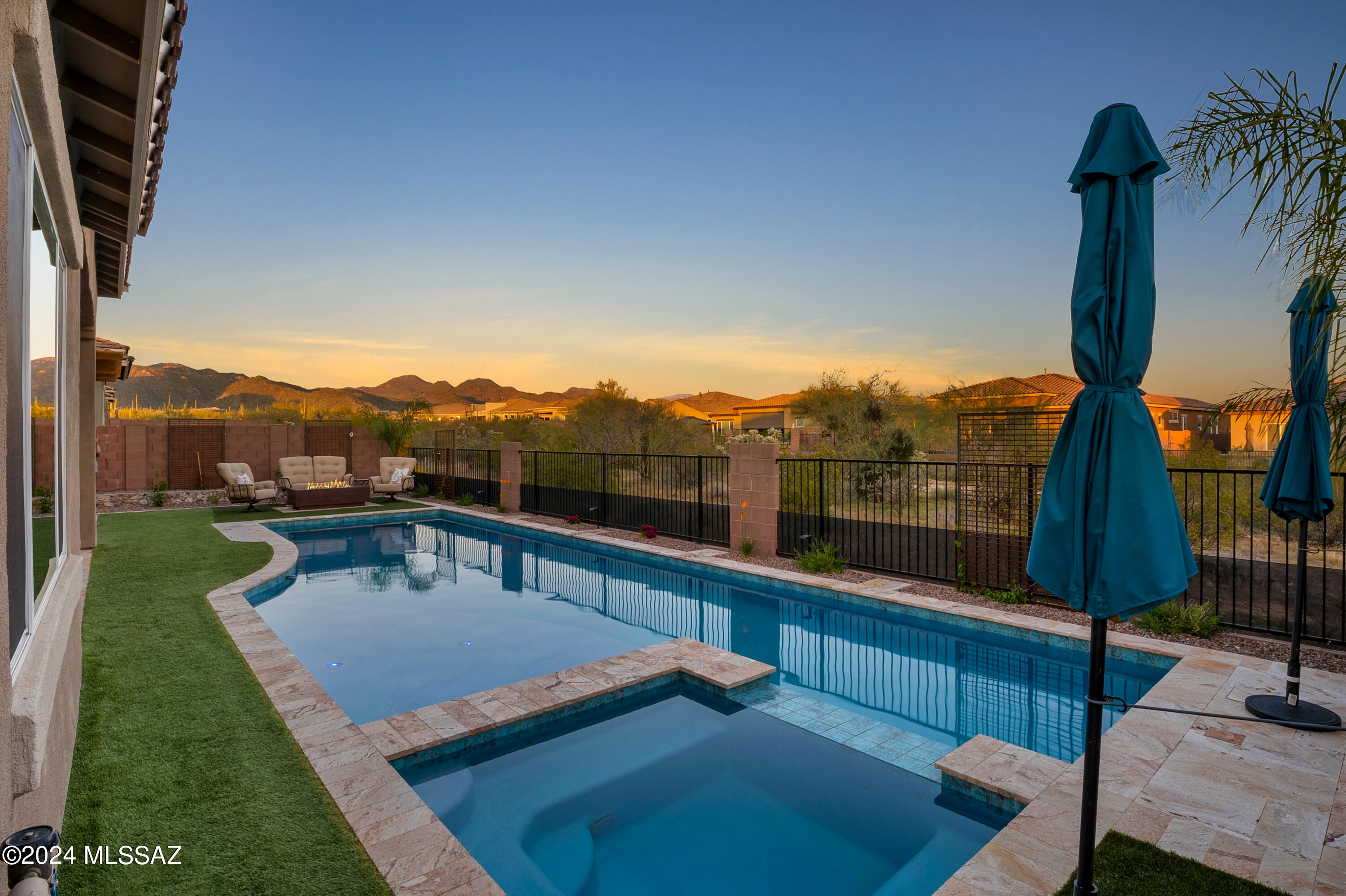 **OPEN HOUSE** Sat. 4/13 11AM - 2PM - One of a kind home in Blue Agave @ Dove Mtn offering your own private resort - practically new! The Mattamy Craftsman Tortolita flrplan starts w/ a 430 sq ft courtyard entrance into the home w/ high ceilings for a grand entryway. The open living space is accompanied w/ natural light from 20' panoramic sliding door. Custom wall features beautiful setting w/ shelves, TV mount, + electric LED fireplace ( for looks & heating). Gourmet chef's kitchen well equipped for entertaining, snacking to fine dining: expansive stone island & upgraded pendants create setting for enjoying any occasion. Head out to your private backyard to enjoy the mountain views, complete w/: pool & spa, w/ water features, pergola, turf, & more. Custom shelving in butler's pantry add a nice finish between kitchen & dining space. Continuing to 4 bdrms, owner's suite joined w/ generous closet & upgraded bathroom shower, 2nd bdrm comes  w/ it's own bathroom while remaining bedrms are just off Teen Retreat/Bonus space - great for multipurpose: study/work from home, entertainment/gaming - anything you can think of!