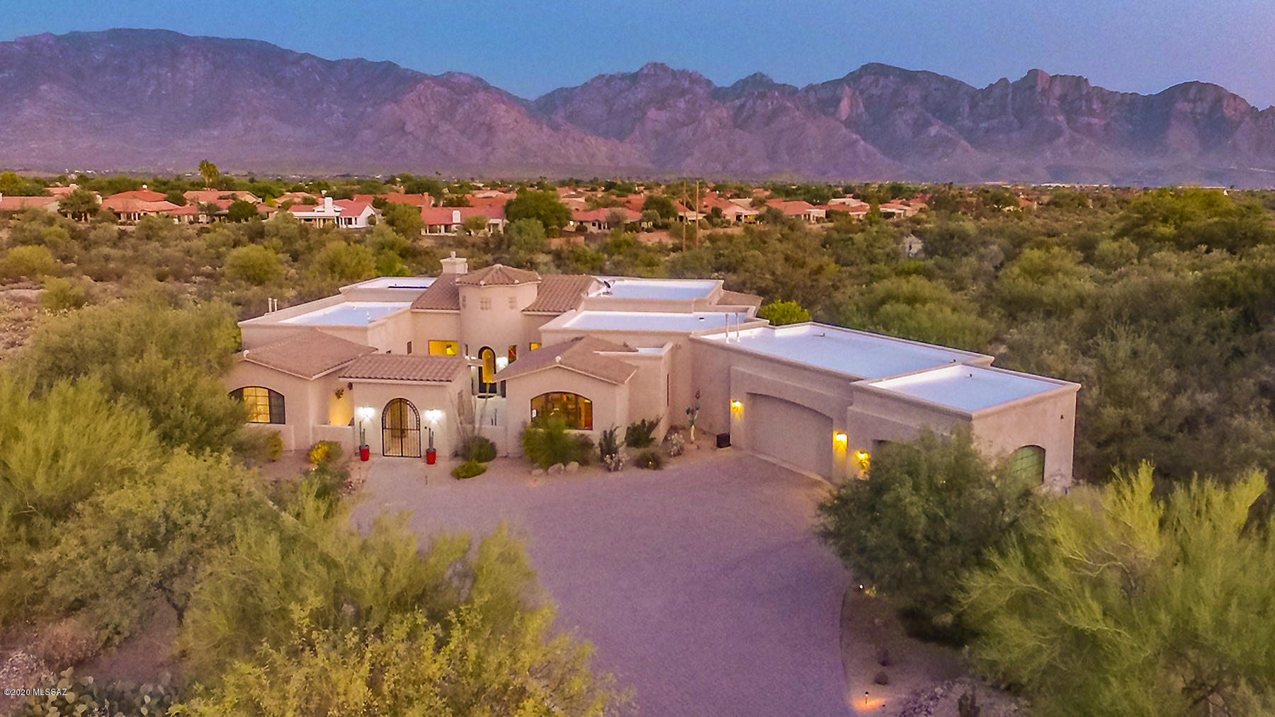Timeless elegance awaits at this 4BD/5BA+Den (4,279 SF) custom contemporary in guard gated Estates at Honey Bee Ridge. Expansive front courtyard w/private Casita is lined w/Travertine which continues into the home. Turreted foyer opens to an impressive Great room w/striking backlit display wall, fireplace & walls of view windows. Sleek gourmet kitchen boasts granite countertops, island/breakfast bar, dining nook, Wolf 6-burner cooktop and butler's pantry w/wine fridge. Master suite hosts a fireplace, dual vanities, jetted tub, frameless shower & custom closet. Enjoy indoor/outdoor speakers & skylights, en suite baths and Casita kitchenette. Resort style yard boasts an expansive brick patio w/firepit, solar heated pool/spa, outdoor kitchen w/bar and majestic Pusch Ridge views. See 3D Tours!