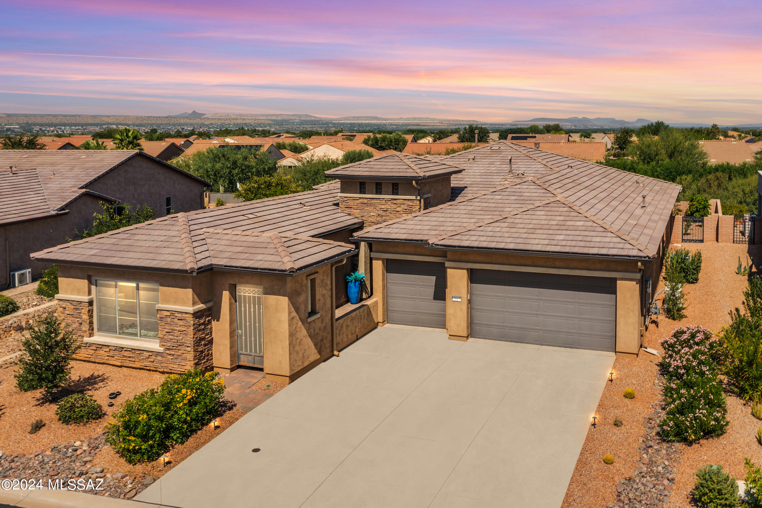 Stunning 2021 Vienta model w/ Casita is well appointed w/ designer touches throughout. Backing to a private arroyo lot, this 3 BR, 3.5 BA +Den home offers 2,768 total sq.ft., incl. a 415 sq.ft. Casita. Interior features incl. contemporary color scheme throughout, upgraded luxury vinyl plank floors in common areas, Great Room w/ 11' ceilings, gas fireplace, wet bar, elec. window shades. Chefs kitchen has gorgeous granite counters, tile backsplash, island, breakfast bar, Monogram appliances, pantry closet. Expanded owner's suite and walk-in closet, spacious bath w/ tile shower, soaking tub, dual vanity, linen closet. Guest BR has en-suite bath. Separate powder room. Large, private entry Casita w/ wet bar/refrigerator and en suite bath is ideal for extended stays or as an in-law suite. Outdoor living is as impressive as indoors! Head to the extended rear paver patio via the 3 panel stacking sliding glass doors, and gather around the outdoor patio fireplace, or dine al fresco. Enjoy the private backyard with lush landscaping, artificial turf, gas firepit, or take a soak in the hot tub. All this and a full 3 car garage w/ overheight doors, plus spacious laundry room close to the owner's suite w/ storage/linen closet. Bonus: home generator gives you peace of mind by keeping your home's power running through a blackout.  Don't miss this truly impressive home!