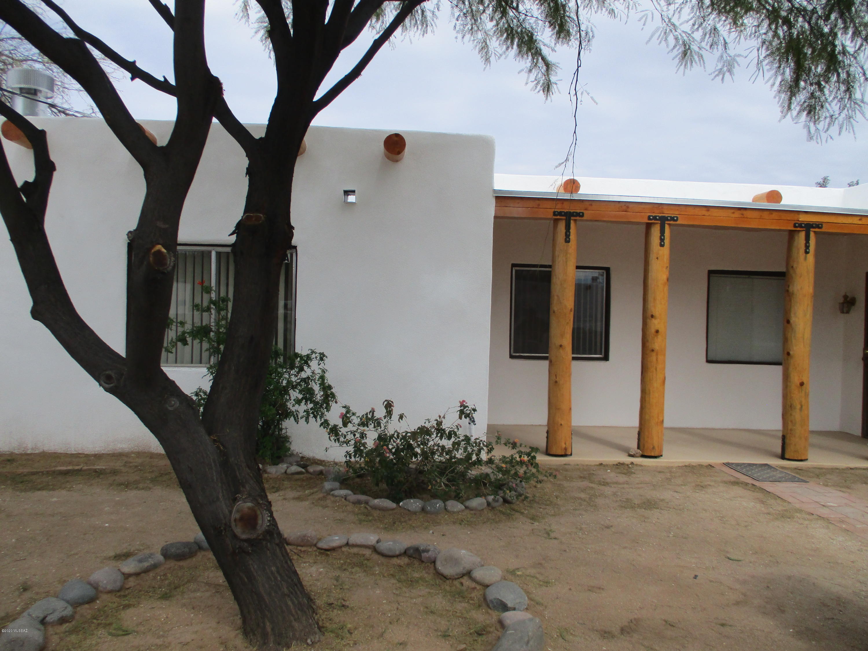 Adorable unit with great ceramic tile throughout. Beehive Fireplace (Wood Burning), Back Porch,Enclosed front and back yard. Secluded, quiet location. Santa Fe Style Architecture Appearance. All utilities are included except Electric and Cable. Covered Parking