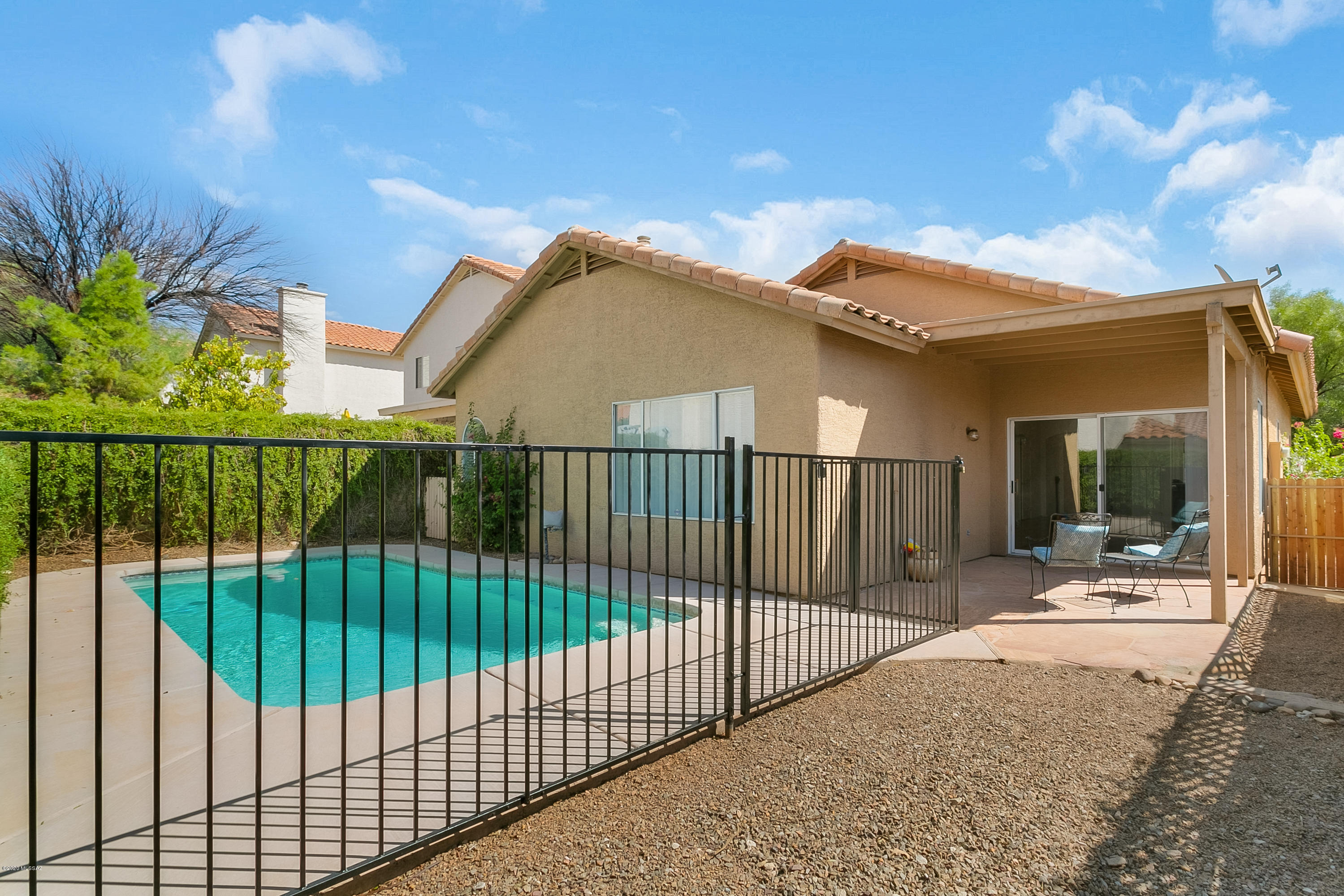 This tucked away neighborhood is simply a find! Just steps away from the Sabino Canyon Recreational Area, this 1-story 3 BR/2BA in desirable Encanto Canyon is located District 16, close to A-rated schools, & world-class shopping & dining. Easy living floor plan on corner lot with vaulted ceilings, lots of natural light & low care backyard with refreshing pool & peekaboo Catalina mountain view. Freshly painted throughout & no carpet, w/saltillo tiled floors & Mexican tile accents lending authentic Old Pueblo charm. NEW stainless steel appliances & smart concrete countertops in kitchen, with updated fixtures & granite-counter baths. Master is private suite with spa-like dual sinks, separate tub/shower & huge walk-in closet. 2 other bedrooms share hall bath. Don't miss this one!