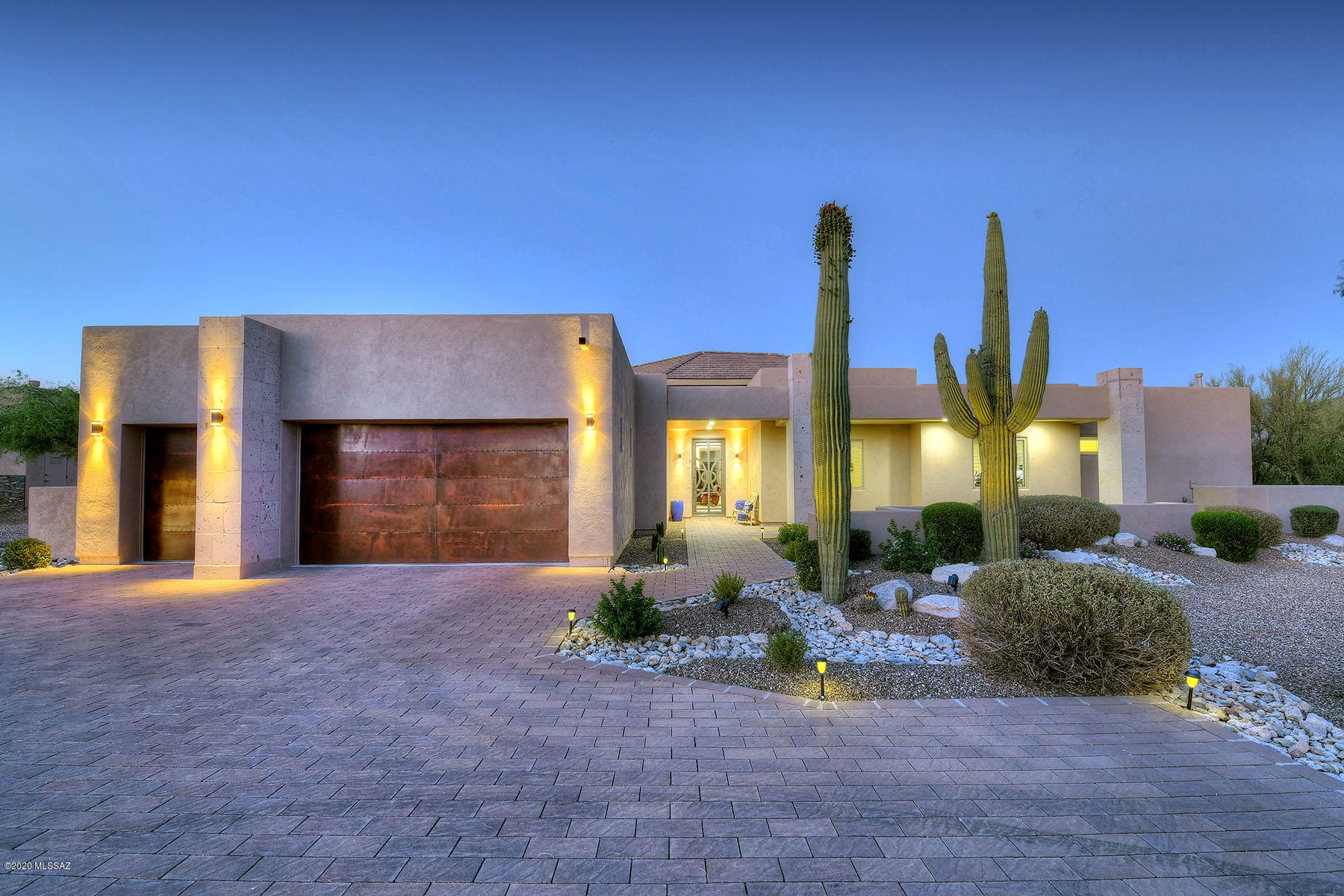 Stunning 2016 soft contemporary on a 1.38 lot in one of Tucson's newest gated communities, Rancho Soldados, near Tanque Verde Rd. and Soldier Trail, with unsurpassed Catalina and Rincon Mountain views.  With 4,524  sq. ft., 4 bedrooms plus den/office that could be 5th bedroom, brick paver driveway leads to custom wrought iron front door into glorious great room/dining room/kitchen with soaring ceiling, walls of windows, wood grain ceramic tile floors, custom window coverings and fireplace between great and dining rooms.  Chef's kitchen features oversized center-island with breakfast bar, granite counters, designer appliances including professional six burner gas range.  Gracious master suite offers fireplace, spa tub, dual walk-in closets, dual vanities and views. Professionally landscaped rear yard has expansive covered rear porch, pool and spa.  Oversized three car garage with copper finished garage doors and so much more.  This one truly is a WOW!