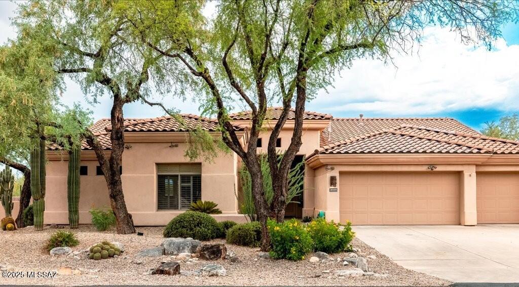 This stunning custom home is located in the gated Lakes at Castle Rock. Sited on .61 of an acre with lush desert landscaping and a serene backyard oasis. This home is 3 bedrooms, 3 bathrooms with a custom chef's kitchen and a 3-car garage. Upon entering the foyer your greeted by soaring high ceilings, fresh white paint and new black light fixtures throughout. The kitchen features plenty of storage and counter space with an oversized granite island, never before used KitchenAid refrigerator, wall oven with convection, dishwasher, GE electric stove top, and a garden window with views of the Rincon Mountains to enjoy from the kitchen sink. The kitchen also offers a dining nook, pantry closet as well as a wall of cabinetry for additional storage. Wall to wall picture windows looking onto the lush backyard and patio sliding door make the family room off the kitchen a warm and cozy atmosphere with a gas fireplace, wet bar access and wired for built in speakers. 

The split floor plan is perfect for hosting or for the family that needs two primary bedrooms. The guest bedrooms share a jack and jill bathroom with dual vanity sinks, granite countertop, and a new limestone shower surround with updated plumbing and black fixtures for a sleek contemporary design. One guest bedroom has a large walk-in closet perfect for the second primary use, while both bedrooms feature stunning white plantation shutters and new black fans. The additional guest bathroom has granite countertops, a bathtub and shower with new plumbing hardware and fixtures and zellige tile. 

The large 480 square foot primary bedroom has plenty of space for a seating area to enjoy the stunning view of the serene backyard. The large ensuite has a new soaking tub with a stained-glass window view, zellige tile shower with dual shower heads, two vanities and an oversized walk-in closet with plenty of storage for two. 

The large main living room is modern and inviting and features the main dining area and a den separated by a pony wall as well as the wet bar, perfect for personal enjoyment and entertaining alike. Stepping onto the back patio wired for surround sound you'll fall in love with the stunningly landscaped backyard desert plantings, apple trees and lighted walkways to the built in natural gas BBQ, pool and spa with a water feature and pergola with a natural gas firepit, seating area and fan so you can enjoy it year-round. This corner lot backs up to 73 acres of common area space so you don't have any neighbors behind you for as far as the eye can see with some city views at night.

The Lakes at Castle Rock is a gated community with 14 lakes and 73 acres of common area. The neighborhood amenities include a pool and spa, pickleball and tennis courts, exercise/recreation area and walking and hiking trails in the desert common area. Near the base of the Santa Catalina Mountains this home is a short drive from Mt Lemon, located near Aqua Caliente park and some of Tucson's best restaurants. Schedule a private tour today!