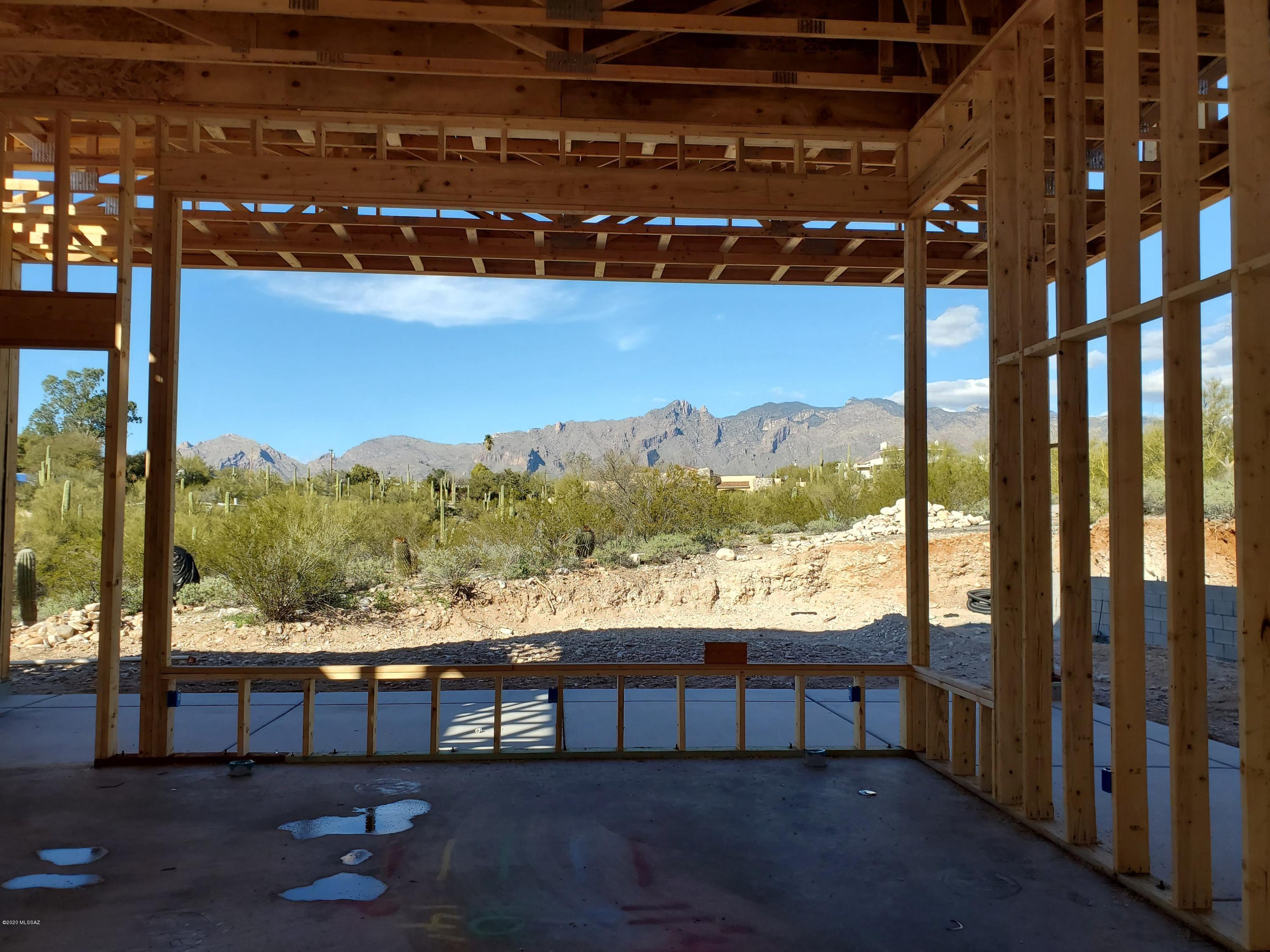 If you act fast, you can still pick the finishes on this gorgeous new custom hm w/amazing mountain and valley light views specifically designed for this incredible hilltop lot.  It's an entertainer's dream home w/huge wall of windows for maximizing the Catalina mtn views in the lg open kitchen/grtrm w/2 islands, beautiful cabinetry, granite, SS appl, walk-in pantry & brkfast nook opening out onto side patio.  The Mstr Ste features more inspiring views, lovely bath, sep shower, dbl sinks & generous walk-in closet.  The dining room and den both have huge picture windows capturing the twinkling lights & sunset views.  Lg laundry rm w/tons of space for extra cabinetry. Great foothills location minutes from all the amenities you may need.  Principals are licensed to sell real estate in AZ.