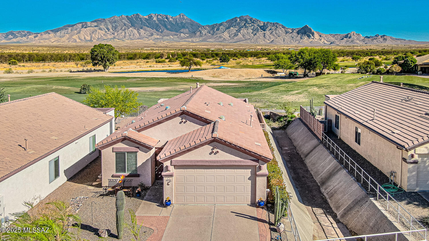 ''VIEWS, VIEWS, VIEWS. Discover the breathtaking panoramic vistas of Santa Rita Mountain and the Golf course from this exceptional home nestled in the desirable Anza Links neighborhood. This Gorgeous 3-bedroom and 2-bathroom home boasts a contemporary open floor pan perfect for the modern lifestyle. The home is perfectly positioned on a lot with a single direct neighbor, ensuring privacy. Beautiful kitchen with granite counters, cherry cabinets with pullouts, Stainless steel appliances and expansive breakfast bar that flows seamlessly integrating with the great room and adjoining dining space. The Great Room, accentuated by a cozy gas fireplace, opens directly to the delightful backyard through a sliding door, unveiling phenomenal views. The main suite - your tranquil retreat, also offers breathtaking views and a walk-in closet for your comfort. The in-suite bathroom has executive height counter tops, double sinks and a walk-in shower. The split floor plan gives the privacy that your family and friends need plus the recently installed HVAC unit (2024) guarantees year-round comfort. The third bedroom offers versatility to suit your lifestyle needs - easily transform it into a home office, hobby room, or keep it as a welcoming guest bedroom.  Unwind and bask in the incredible panoramic views that the fantastic backyard with pavers, extended porch, pergola, and view fencing has to offer. With a water softener barely 2 years old, attractive wrought iron security door, ceiling fans in all bedrooms, and a fully equipped laundry room with a washer and dryer, the home is replete with amenities. Experience an active lifestyle that the Green Valley recreation membership offers  - pools, gyms, pickleball courts, classes, entertainment, and shows. Golfcart in garage available by SBOS. Perfectly situated, the home is just a stone's throw from the Torres Blancas Golf course and the renowned Anza Trail along the Santa Cruz River - a paradise for outdoor enthusiasts. Additionally, the I-19th and shopping area are conveniently accessible.  All around a great home that you can not miss! "