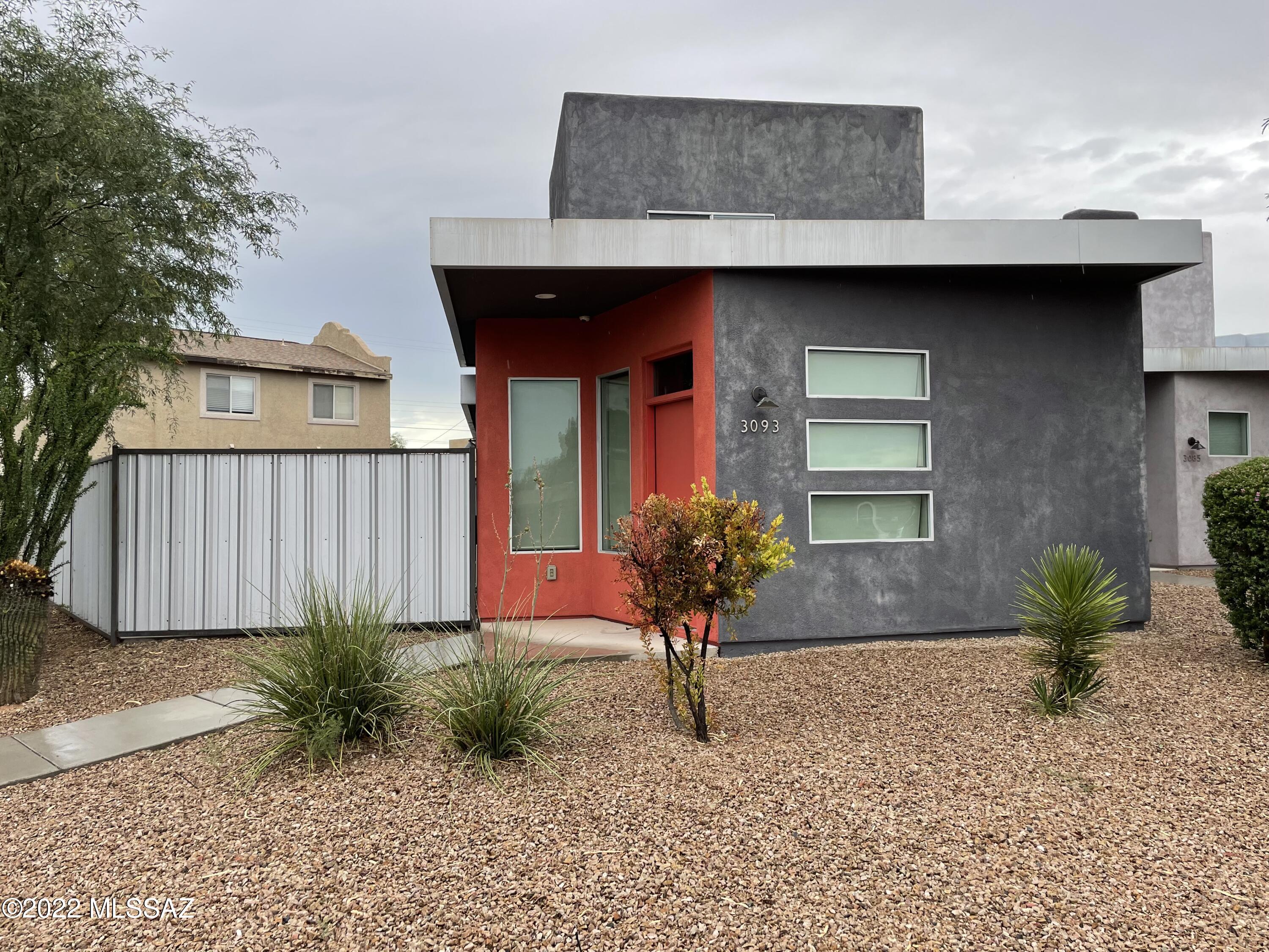 Contemporary Architecture inside and out!  Open living area includes spacious greatroom with strategically placed windows, opening into  a modern kitchen with stainless steel appliances, island and loads of cabinet space. There is even a powder room on the ground floor! Garage enters right into the kitchen making it a breeze to bring in the groceries! Sliding glass door opens up into yoru private patio ''ard'' area with uncovered patio and landscape rocks. Add a few pots and furniture for an amazing private outdoor living space. Two bedrooms both with their own ensuite bathroom, linen closet and full size stackable washer and dryer round out Upstairs. Wood look tile floors everywhere but bedrooms. This home is in close proximity to U of A, Banner, and Downtown +++!