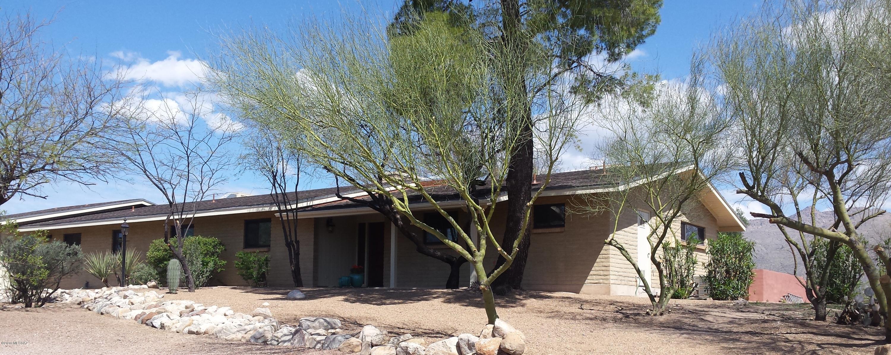 Amazing renovation of a Tucson ranch classic on four lush acres. Spectacular views of the Catalina and Rincon mountains. Open floor plan with living/dining & family room. Fantastic kitchen w/ granite counters, beautiful maple and hickory cabinetry, new stainless appliances and huge center island. Spacious master en-suite with double sinks, hickory cabinets, custom shower surround and huge walk-in closet. Large guest bath features granite counters, double sinks, tub & separate shower. Pool & Covered porch that extends the full length of the house. Beautifully landscaped rear yard. Two attached car garage plus one-car garage/workshop/stable (?)