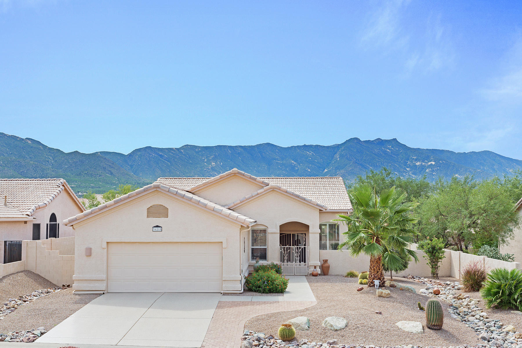 Beautiful Fiesta with 2 very large bedrooms, living and family room and unusually large Hobby Laundry Room expanded 4 ft. This room can well be adapted to an office with fine counter space. The full rear porch has a lovely view of the Catalina Mts. with eastern exposure. The house is handsomely upgraded with newer tile and carpet and has hardwood flooring. Master bath is upgraded, kitchen has corian countertops and newer cabinets with lovely tile backsplash, newer dishwasher and frig.  HVAC 2015 and newer hot water heater. Garage has attic storage. The full back patio has oranges, lemons and peach trees. Make this your lovely retirement dream. Welcome Home!