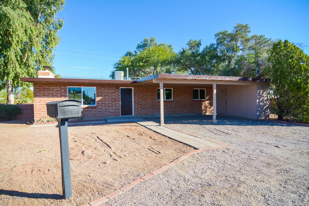 Beautifully remodeled Ranch style home. Located in a convenient East Tucson location. Charming brick construction. Rich wood laminate flooring. New modern kitchen with granite counter tops and stainless steel appliances. New custom interior and exterior paint. New upgraded carpet in bedrooms. Completely remodeled modern bathrooms. Nice back yard with mature vegetation.Two car carport. Storage shed. Upgraded door hardware and light fixtures. This home shows beautifully.