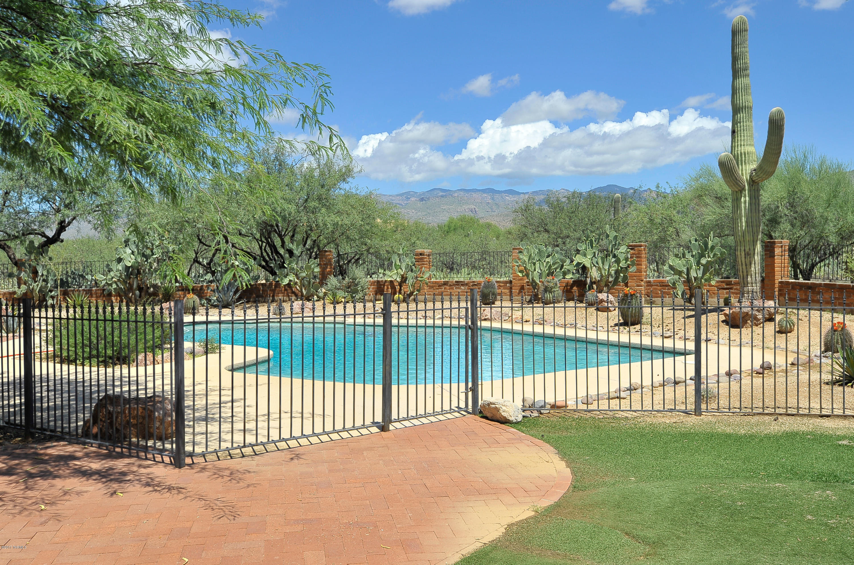 Wonderful spacious home in peaceful and serene La Cebadilla Estates.  Equstrian SW Burnt Adobe home sits on over 3 acres.  Natural desert landscaping with wonderful mountain views.  Swimming pool, and horse facilities. Kitchen has large island w/sink, built in wine fridge and natural hickory cabinets. 5 Bedrooms (1 is a studio guest quarter) 5 Baths, 2 fireplaces and so much more.  You don't want to miss this spacious home. Pool service and maintenance covered by Owner; chemicals are an additional $30/mo.