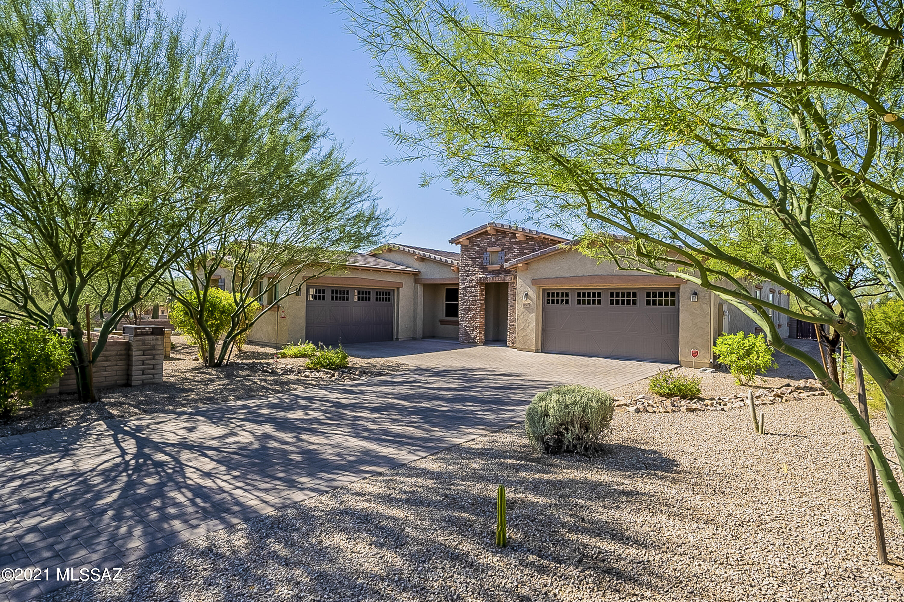 Rancho del Cobre is a delightful open-space gated community in Oro Valley. School shopping is just minutes away and surrounded by the majestic Catalina Mountains. This spacious Arrowhead floor plan is nestled against lush and mature vegetation and has room for everyone on this 0.46-acre property. Featuring 4-bedrooms, 3-bathrooms, and gourmet kitchen with upgraded granite counter top, custom kitchen backsplash, Cherry Java cabinets, pendant lights over kitchen cabinets, two-tone interior paint, coffered ceiling at foyer, expanded covered patio, 20'' x 20'' floor tile, the gas line to patio for future BBQ, paver driveway, soft water loop, and so much more! Oh yes, a 4-car garage with epoxy flooring and cabinets.