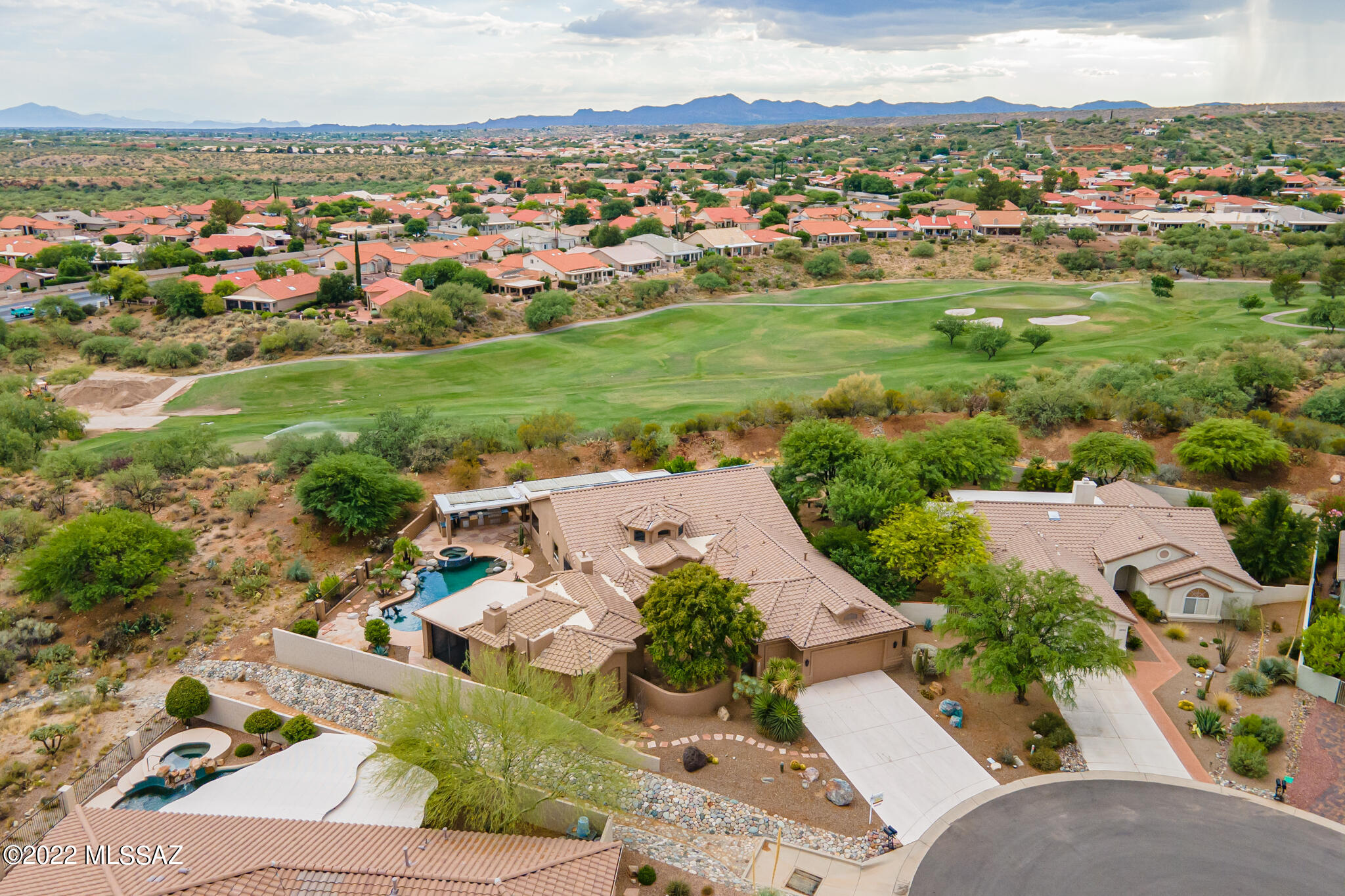 One-of-a-kind estate sized home majestically perched on ridge. Private .30 acre lot in cul-de-sac. Resort-style backyard w/solar heated saltwater pool/spa w/mtn view. Award winning floorplan expanded, customized & upgraded. Circular foyer w/cupola,  clerestory windows & columns open to formal living room, dining room & library. Pub w/custom bar & FP. Chef's Kitchen & Nook, huge island, Sub Zero & Wolf appliances, abundant cabinets & granite. Wine coolers & icemakers in Kitchen & Pub. Outdoor kitchen. Primary Suite w/fireplace & luxury bath. Guest Room #2 used as office with built-in desk & cabinetry near updated Powder Room. Guest Bedroom w/nearby bath. Large Laundry/Hobby room.  Ext'd 2 car & golf cart garages. 24'' travertine floor tile. Artistic touches. Owned solar.