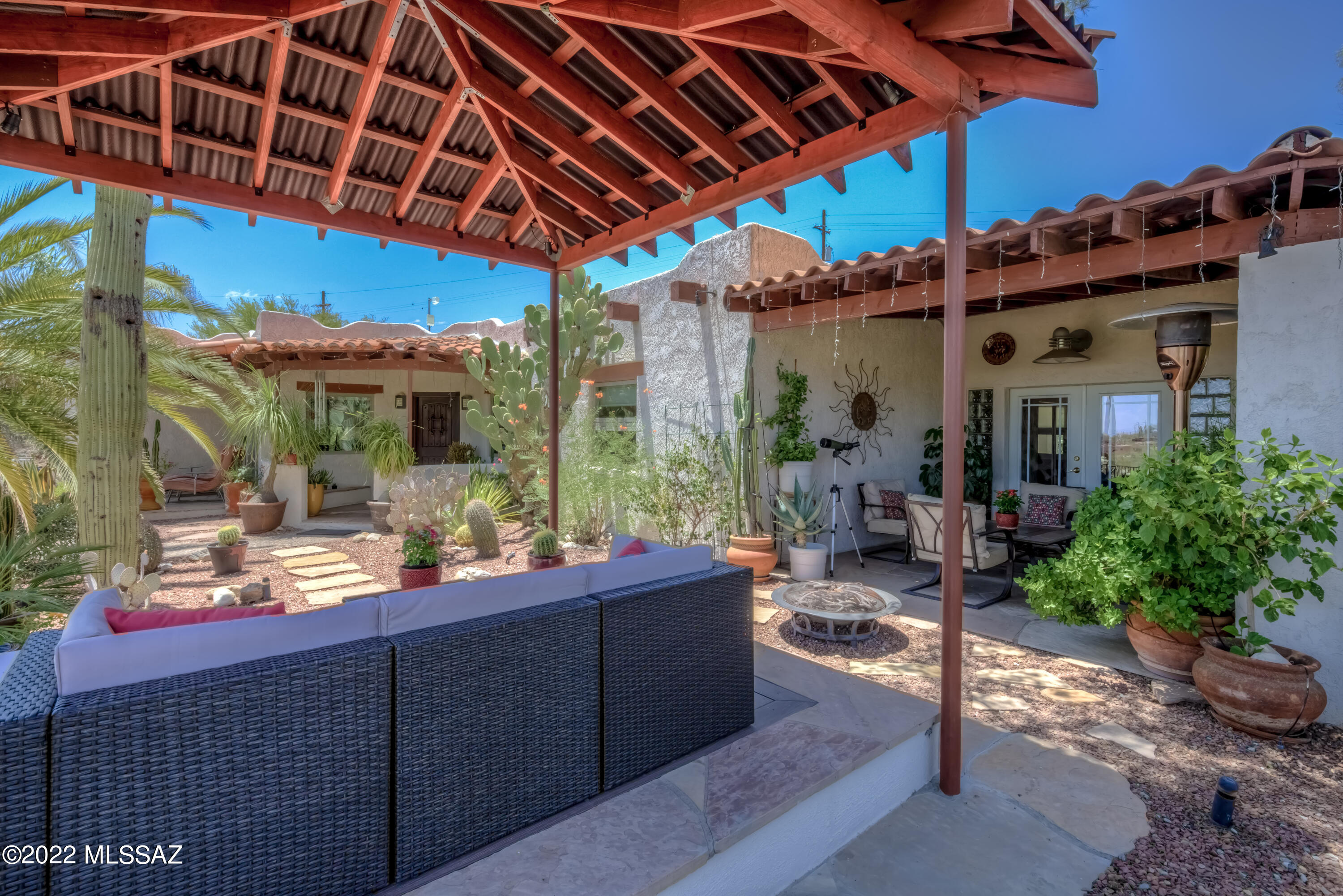 Motivated seller offering an amazing outdoor livings areas includes a patio, a pergola, private courtyard, views of the Catalina Mountains, city lights and neighboring wash. Come inside to find a contemporary style kitchen and connecting counter bar area, living room with a fireplace and natural lighting through large windows and added solar tubes and sitting or TV room. All of this then leads to 3 bedrooms that are perfect for an office, guests and a primary bedroom that impresses with both a walk-in closet and luxurious bath.  The neighborhood is extremely private on oversized lots and tucked away in the Oracle Foothills on a road you probably never knew existed and yet is so close to town to make anything super convenient. Don't let this home pass you by. Call to book a tour today Don't forget the detached 2 car garage that boasts an oversized workbench and space to store all kinds of crafts and materials to be a workshop that artist or craftsman could need. In addition, space and power for an RV is available on the east side of the lot with separate access from the main road
Seller to provide roof replacement at time of close with full price offer - see attached roof quote