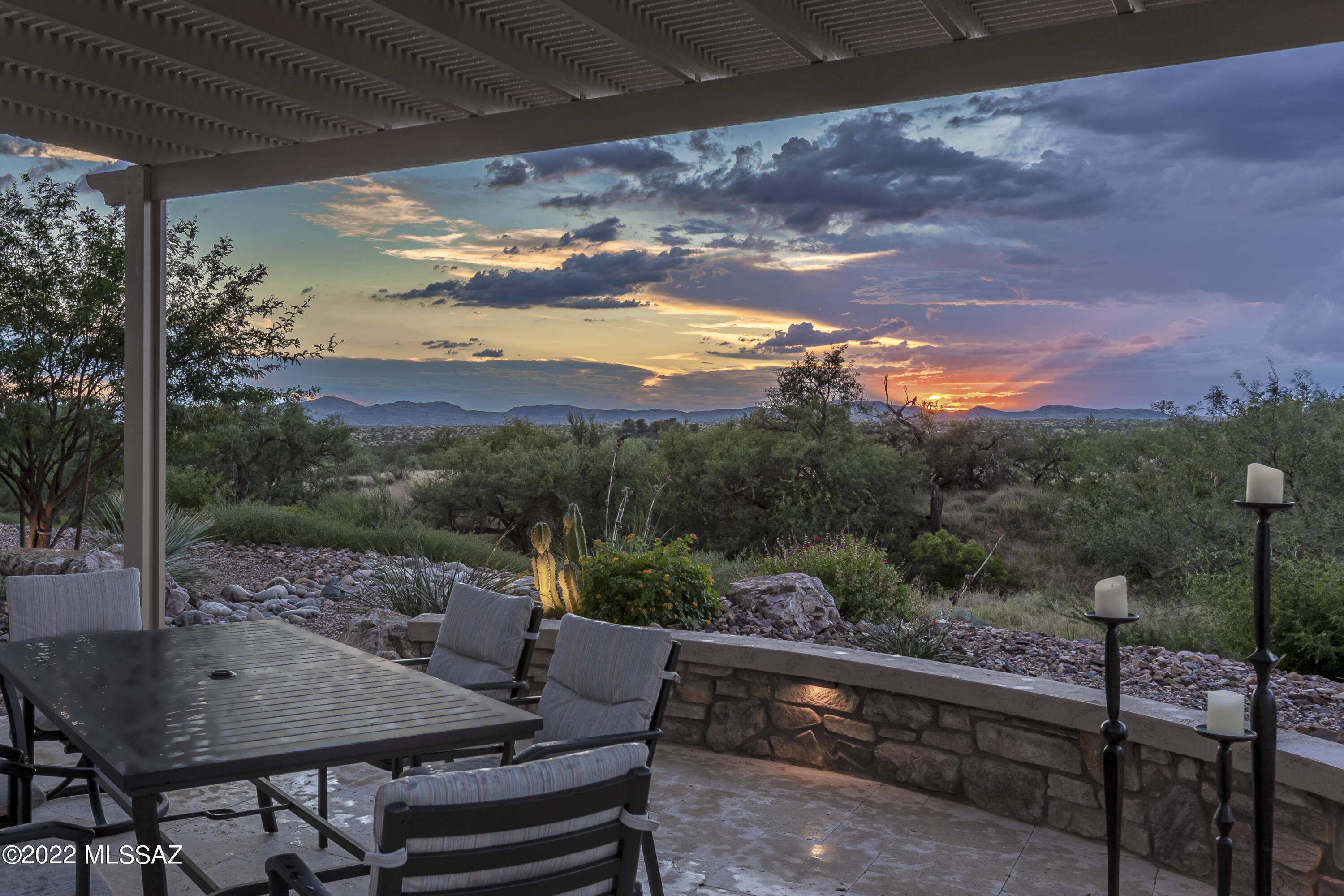 Discover a rare gem in this beautifully upgraded Vienta w/outstanding panoramic mountain view.  Delight in an extended travertine patio w/shady pergola & adjacent outdoor granite topped bar including BBQ.  Enjoy glorious sunsets under your covered patio w/gas fireplace & full rolling screens.  Inside you'll find a generous island & well appointed kitchen w/premium microwave & convection wall oven, range hood, under cabinet lighting, & reverse osmosis.  A side buffet by the great room makes entertaining easy while special 3M room darkening coated windows reduce glare.  Beautiful glass French doors at den.  Custom walk-in closets, framed mirrors, upgraded light fixtures, & full tile surrounds in both master & guest.  Epoxy coated garage floor & driveway w/golf cart garage & 4' added length.
