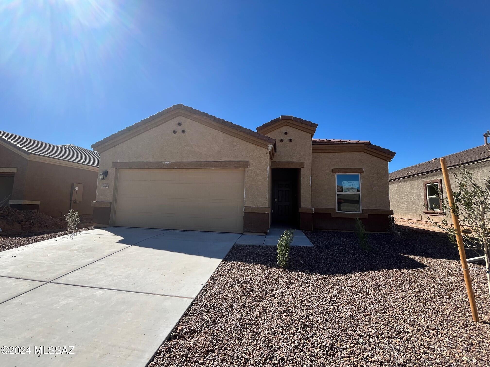 The open floor plan features a welcoming interior, comprises a flow-through living/dining area, a good-sized living room, and high ceilings. Entertain in style in this efficiently designed kitchen that features a Whirlpool dishwasher, microwave, gas stove, beautiful granite countertops, and, a large granite island. The comfortably sized owner's suite is an oasis of peace and relaxation, and the primary bathroom has a large walk-in closet. The technology suite includes a Wi-Fi-enabled thermostat, smart irrigation systems, and keypad door lock, an Amazon Echo Pop, a Honeywell T6 Pro, and more. The good-sized backyard offers a covered patio and space to add a pool or an outdoor kitchen. Enjoy resort-style living at Saguaro Bloom with the community's 12 pocket parks, pools, and more!