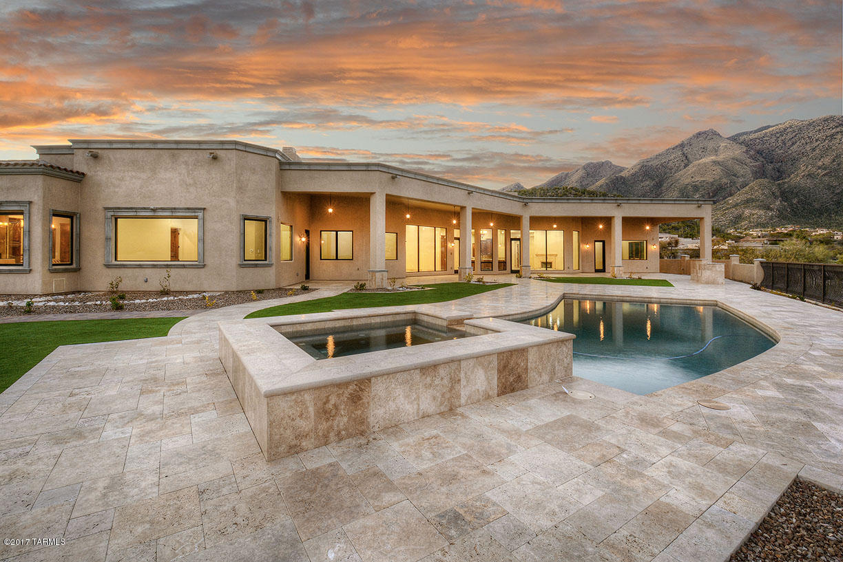 Seller will accept or counter offers $2,000,000-$2,500,000. ''Stunning'' does not begin to describe this brand new, 2017, six bedroom, 6107 sqft custom home on the side of a hill in the Catalina Foothills w/sweeping Catalina & Rincon Mountain & city views, backing up to an approximately 50 acre common area desert. Paver driveway and personal electronic gate leads into courtyard, to custom wrought iron entry door into living room w/soaring ceiling & walls of windows, custom wrought iron light fixtures, travertine floors, 9' alder doors & custom alder wood work throughout. Cook's kitchen offers granite counters, oversized center island, stainless steel appliances custom cabinetry & fabulous wine cellar w/independent cooling. Gracious master suite features spa tub, dual vanities & dual walk-in closets w/custom built-insFour car garage, glorious rear yard with expansive rear porch with travertine floors, outdoor kitchen, pool/spa and awe-inspiring views. Must see to appreciate.