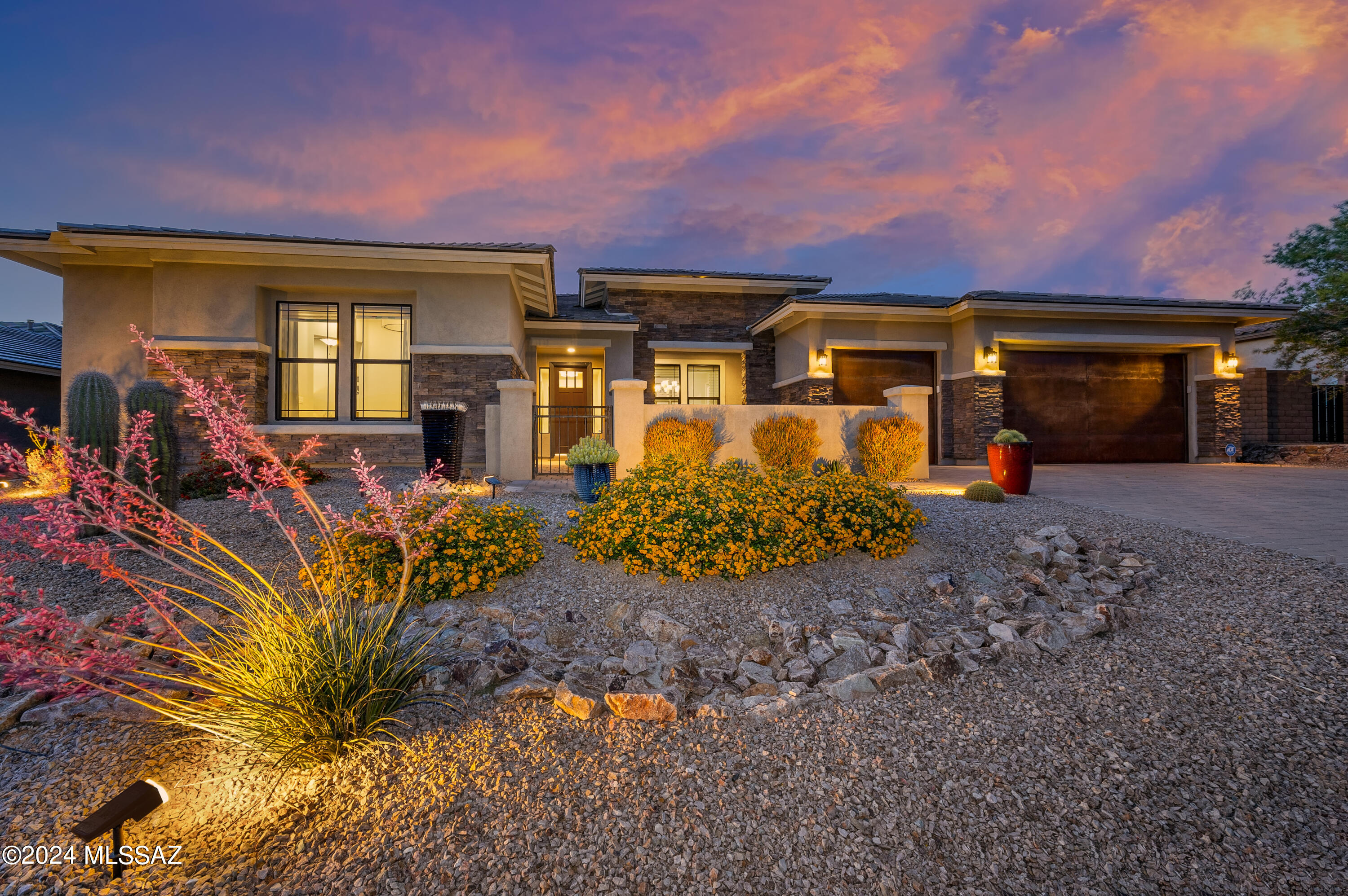 Located in the prestigious gated community of Boulder Bridge Pass in Dove Mountain, this exquisite property is available to the market for the first time and is THE ultimate in luxury and functionality!   It has been professionally decorated throughout and looks and feels like a model home with every upgrade available selected at build. Sitting on a premium golf course lot (Saguaro 2), this home offers 5 bedrooms, 4.5 bathrooms, 4,062 square feet, enclosed den and a 3 car garage.  The sophisticated great room design is complemented by coffered and soffit ceilings, gourmet kitchen, butler's pantry with wet bar and wine fridge, expansive island, upgraded cabinetry, quartz countertops, a 6-burner GE Monogram range with griddle, a large side-by-side Monogram fridge and freezer, under-cabinet lighting, and a pot filler for added convenience. With a formal dining room, a casual dining area, and a 6-seater island, this home offers ample space for entertaining. The oversized owner's suite includes two walk-in closets, dual vanities, an expansive walk-in shower with both regular and rain shower heads and a luxurious soaking tub. The large laundry room is complete with sink, cabinetry and has a pass-through to the owner's suite closet for added convenience. Your guests will enjoy the privacy of the separate guest quarters which features a private entrance, living space and kitchenette - complete with wine fridge and microwave. Additional features include an upgraded alarm system, water softener, reverse osmosis, in-ceiling speakers, and in-floor outlets in the living area. There is an easy flow from indoors to outdoors with the telescopic sliding doors taking you out to the backyard oasis -  multiple lounge areas, large stone fireplace, heated salt water pool with water feature and smart remote technology, swim-up bar, a sunken BBQ area, travertine pavers and artificial turf  - perfect for year-round enjoyment!  The golf course lot provides breathtaking views of the Tortolita Mountains creating a serene backdrop for your everyday living. Experience the ultimate in luxury and functionality of this home where every detail has been thoughtfully designed to offer a lifestyle of comfort, elegance, and sophistication. Don't miss the opportunity to call this stunning property your new home.