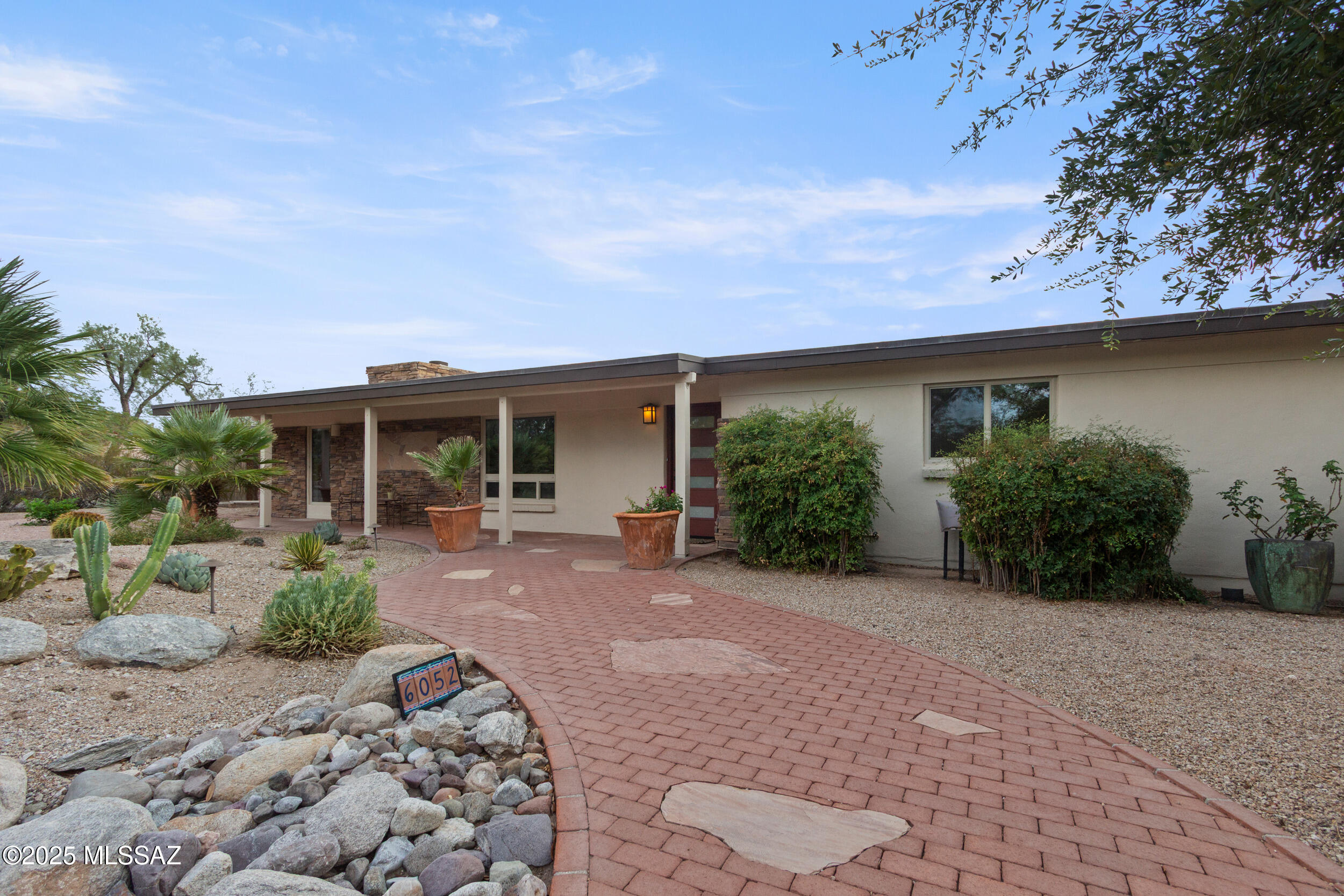 Exceptional home in sought after guard-gated Tucson Country Club Estates.  
This 4 bed/3 bath home has been lovingly upgraded with a professionally landscaped front yard plus beautifully designed backyard featuring recently installed WIFI controlled pool/spa and adjacent lighted ramada which boasts a sensational outdoor fireplace. Spacious primary suite incorporates beamed ceiling, gas fireplace, spacious closet off the en suite bath. Chef's kitchen includes Monogram/Bosch appliances, ample storage and views to backyard oasis. Enjoy your Spanish tile, custom alder doors, and new full-home water filtration and Dual HVAC systems offer year-round comfort. HOA-previously approved architectural plans are available for a new 3-car g A new live-in suite is envisioned in architectural plans for the existing garage. Further, the lot size offers opportunities for other additions.