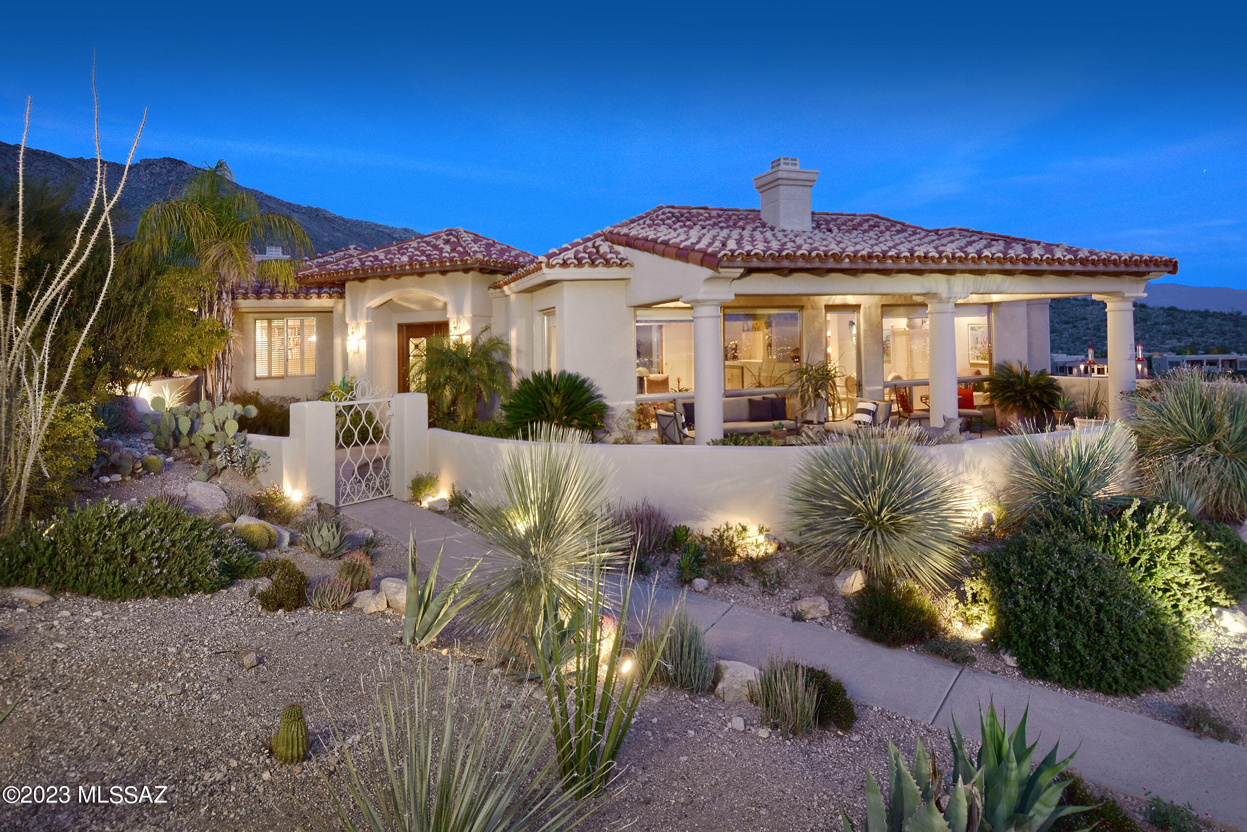 Enjoy forever views from this remarkable property on one of the best lots in coveted Finisterra.  The 3229 sq.ft. house wraps around a lushly landscaped yard w/mature fruit trees, kiva FP and BBQ. The elegant interior, designed by Lori Carroll , features custom finishes and creative use of space.  The contemporary glass and wrought iron front door, unique LR cabinets, and luxurious master bath w/sandstone floor are a few of the special features. The spacious great room & separate DR open to a covered front patio w/stunning mtn & city views. The chef's kitchen w/Viking gas range, granite countertops, and a cozy breakfast area is delightful.  The primary suite w/nearby office and 2 guest rooms are in separate wings offer privacy.   The 3-car garage has a large work area & tons of storage.