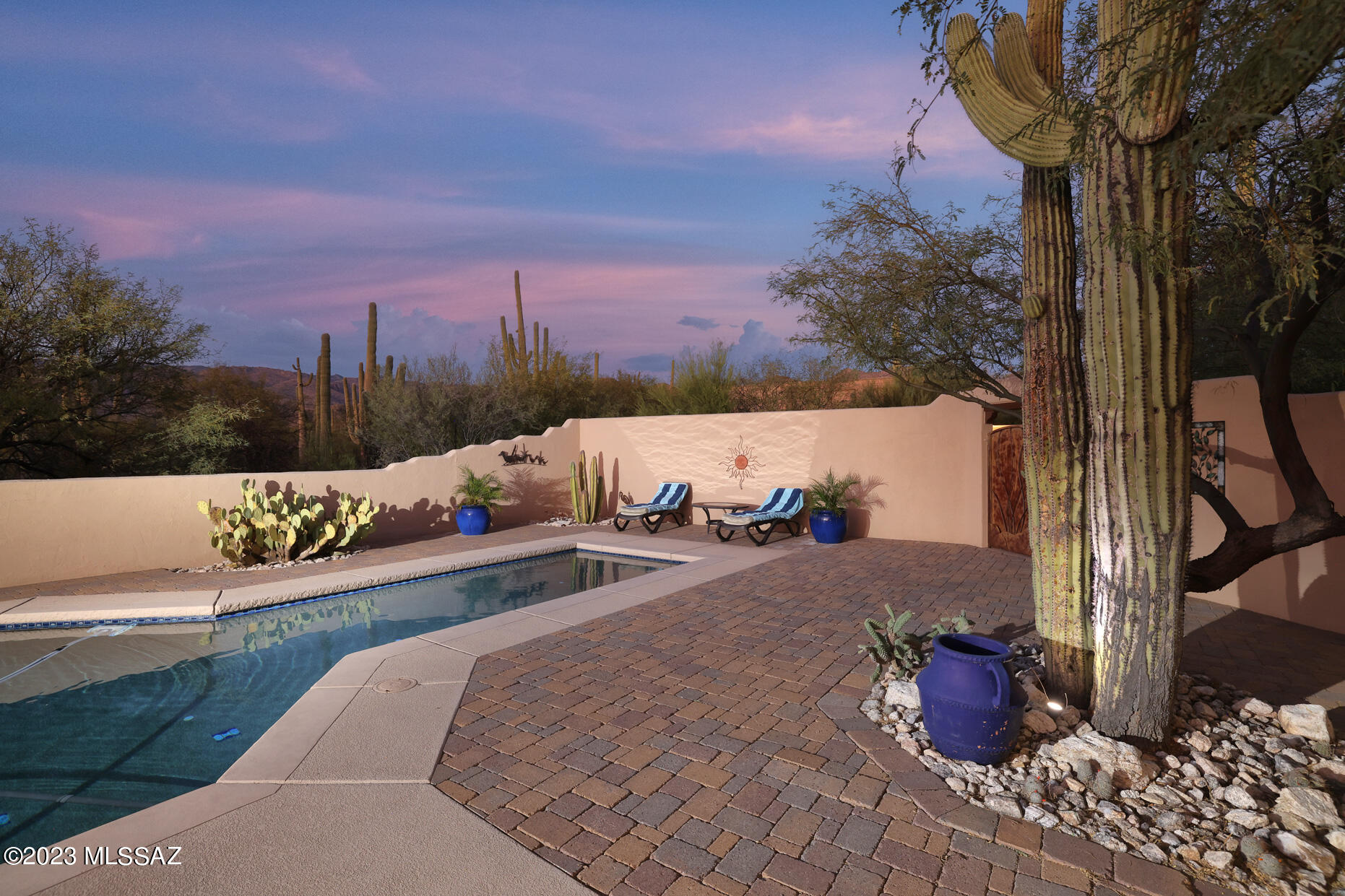 Stunning property nestled in the Tanque Verde Valley with Majestic Views of the Catalina and Rincon Mountains. This 3.64-acre property with dozens of mature Saguaros offers several outdoor areas to relax and enjoy Tucson living. The Resort like outdoor Oasis also offers a pebble-tec pool & spa, outdoor kitchen area and covered back patio. Magnificent views from every window of the home. This 4 bedroom 3 bath split floorplan home includes owned solar providing almost zero electric charge with additional passive solar heating for the pool and spa. Gated entry with paved road access, 3 car garage with workshop and loads of storage. This gem of a home is a very special place to call ''Home''.        Highlights of the Home include: 
•	3.64 Acres of Stunning Desert Scenery 
•	One story liv "	Uninterrupted 360-degree Mountain Views
"	Dozens of mature and developing Saguaros
"	Front Courtyard Entry
"	Rear Paver Courtyard with several seating areas and high 
        wall enclosure
"	Barbecue area/ kitchen in Rear Courtyard
"	Backyard Oasis with drought resistant plants
"	Irrigation system with remote control
"	Large Pebble-tec pool and spa
"	Passive solar heating for Pool & Spa
"	Gated Entry w/Paved road access
"	Concrete Driveway
"	Decorative Metal gates throughout

House
"	Three Guest bedrooms (all fit king beds)
"	Primary Suite w/jacuzzi tub and large walk-in shower
"	Extra large walk-in closet in Primary Suite
"	Split bedroom plan
"	PV Solar (owned) means almost zero electricity charges
"	Large formal living room with high beamed ceiling and gas 
        fireplace
"	Separate Formal dining room
"	Spacious Family living area with fan assisted gas fireplace
"	Breakfast nook
"	Large covered patio accessed from Primary Bedroom, Living 
        room, and Family room
"	Travertine floors through living areas
"	Neutral color scheme
"	Mountain views from every window
"	Separate laundry room with sink and storage
"	Large 3 Car garage with storage and adjacent store room
"	Newer HVAC units (2 units) - 3 years young
"	Newer Water Heater - 3 years young
"	Water Softener (owned)

Kitchen
"	Light and bright with skylights and views
"	Granite countertops
"	Stainless steel appliances
"	Pantry
"	Breakfast nook
"	Reverse Osmosis for Kitchen sink