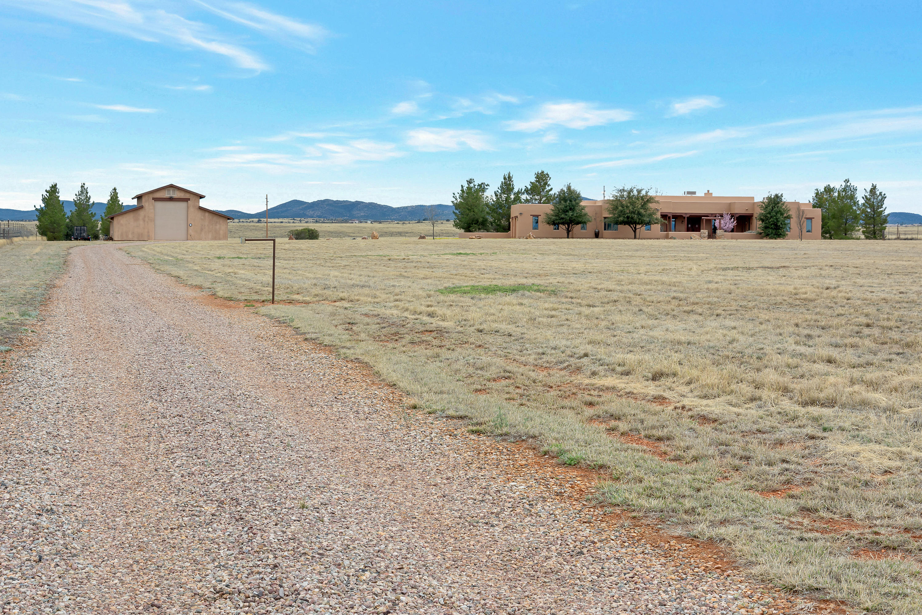 Sellers will accept or counter offers from $789,900 to $924,900. High Desert Hacienda Where Solitude and Beauty Abound And an Architectural Gem Awaits with 2 Purchase Options: (a) 18.16 acres for $789,900 or (b) 37.83 acres for $924,900. This stunning Santa Fe style home is located on the high desert grassland of S.E. Arizona's ranch and wine country. Among its many exceptional features are 2 large master suites (650 & 560 sq.ft.) , high ceilings (14', 12', 10' throughout) and an expansive, open floor plan. A fully insulated, 2,000 sq.ft. (40' x 50') all-purpose building includes a large workshop, extensive built-in storage and room to park a 44' RV. The property enjoys mountain views in every direction and is adjacent to a 30,000 acre Babacomari Ranch. A remarkable property in every way. Features Include:
Home General: Four Bedrooms (Two Master suites), Great Room, Dining Room, Study/Office, Entry Hall, Card Room, 31D2 Baths, 3-Car Garage with Exercise Area.
Multipurpose Building: 40' x 50' (2,000 sq.ft.). Large workshop and extensive built-in storage. 3D4 bath. RV storage up to 45'. 30 and 50 amp service. Two 14' overhead doors.
Architectural Features
Hand-crafted log beam ceilings in most rooms
Italian porcelain tile floors throughout
Custom solid rustic cherry kitchen cabinetry
Custom solid alder cabinetry in baths, office and hallway Marble countertops in kitchen
Granite countertops in baths, office and laundry room
Andersen windows and doors with mesh screens
8' custom cedar plank, wire-brushed interior doors by Butler
2x6 frame construction for maximum insulation and energy efficiency 14', 12' and 10' foot ceilings
Front and back covered patios with walled garden areas
Great Room
14' custom rock fireplace Built-in sound system.
Kitchen
Stainless steel appliances:
GE Monogram: 6-burner stove w/griddle. Side-by-side refrigerator/freezer. Dishwasher. Advantium convection oven/microwave.
Trivection self-cleaning oven
Island: Large workspace, with prep-sink and storage
Master Bath
135 sq.ft. His & Her divided Walk-In Closet with extensive built-in storage 4' x 6' Glass Block, Surround Snail Shower
Kohler 6' whirlpool bath with air-jets
2nd Master Suite
Separate Sitting Room, bathroom and walk-in closet with built-in storage
Office
Laundry Room. 8'x12' with 12' granite work/folding counter, utility sink and a full wall of cabinets and laundry separating bins. Plenty of room for washer, dryer and two refrigerators or freezers.
Heating and Air Conditioning. Three heating and cooling zones controlled by separate Trane HVAC units utilizing both electric and gas for maximum comfort and economy. Casablanca ceiling fans throughout.
Water. Property has its own, private water well. The home has two hot water heaters, both with recirculating hot water.
Security System. Hard-wired.
Fencing. Property is surrounded by 6' field fencing with solar powered front gate. comer
