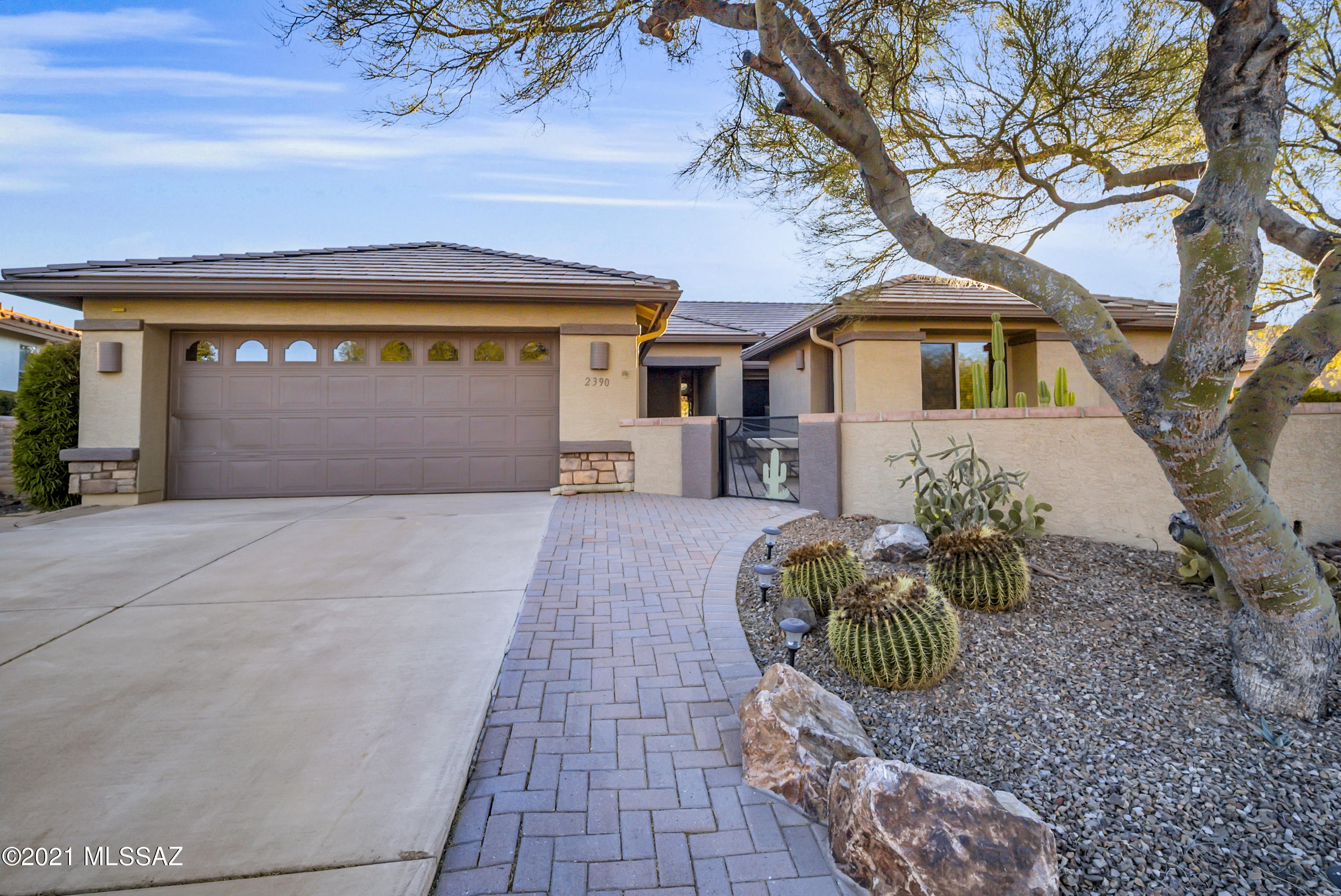 Mediterranean roof lines and a boundless brick walkway lead you into the gated courtyard where a private guest casita provides your overnight guests and family members with their own private quarters.  And solar power will keep you on an even budget throughout the year!  You'll enter a vast great room with Cathedral ceilings with an array of view windows, a built-in media center and a blanket of desert tone floor tile.  Your prep-cook kitchen island features a dual basin sink with a gooseneck fixture for easy cleanup while you converse with guests as they relax in the family room.  The open space kitchen has abundant quartz countertops and full backsplash for easy care.  Dine in the kitchen's eat-in nook surrounded by bay windows or catch up on some bookkeeping in the built-in desk area. You'll appreciate the owner's suite with glass patio doors offering beautiful views and access to the outdoor patio.  Enjoy evenings on the extended covered patio where colorful brick pavers stretch into a barbeque cooking area with built-in sitting benches and a warm adobe style Kiva fireplace.  You'll be awed by the Santa Rita mountain views while you relax to the sound of your trickling waterfall and pond.