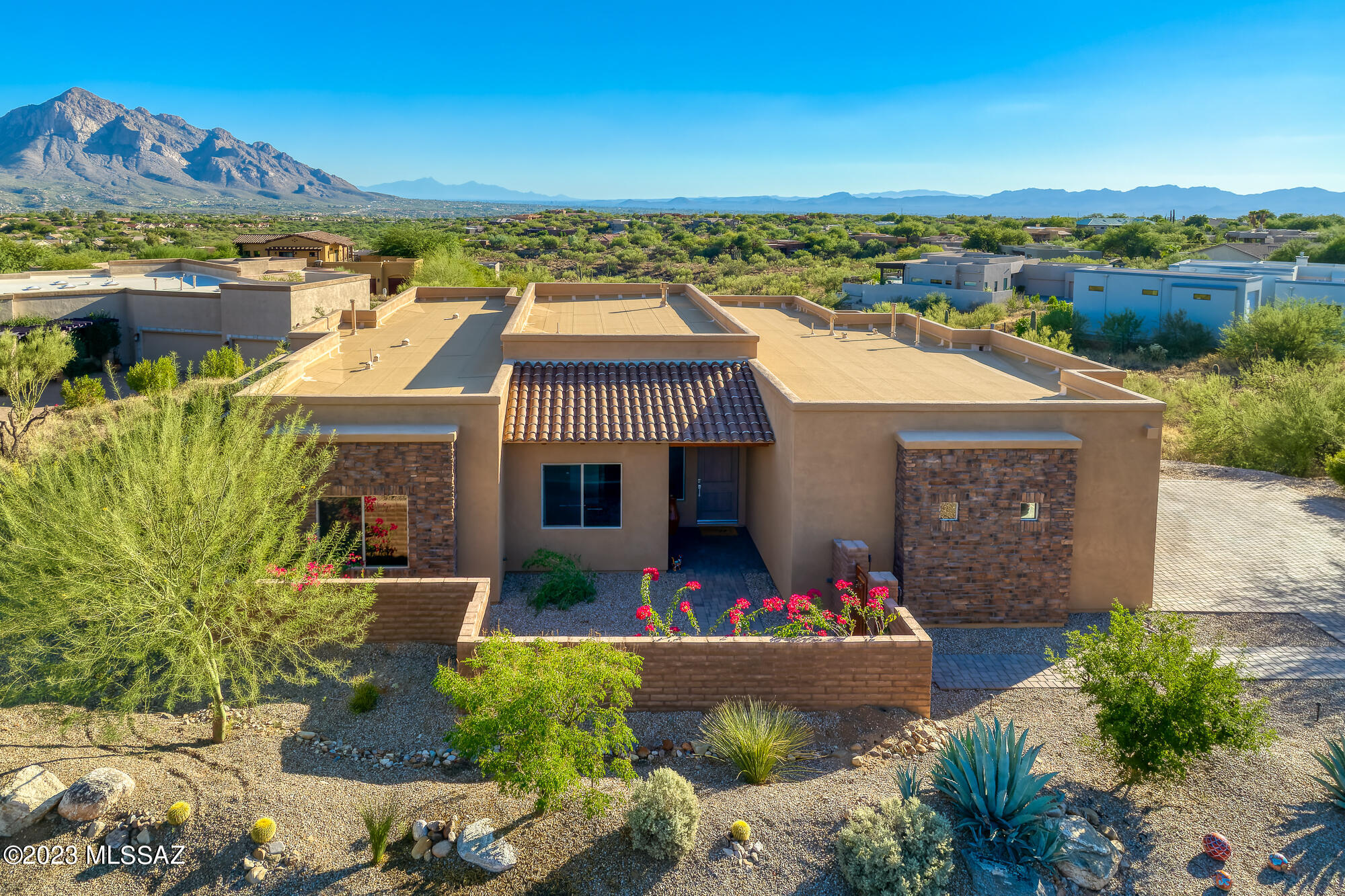 Spectacular transitional style 4BD/3.5BA (3215sqft) home with pool & breathtaking 
mountain/city views. Located in the heart of Oro Valley in desirable gated community Vistoso Pointe. Open concept w/ walls of windows showcasing the views. Modern Italian tile throughout, fireplace, & 8ft alder wood doors. Gourmet kitchen has oversized island, KitchenAid appliances, wine fridge, granite counters & alder wood cabinetry. Spacious owner's suite has luxury bath w/ dual sink vanity, free standing soaker tub, walk-in shower, & his & hers walk-in closets. Relax in bed or soaker tub & see mountains, city lights & stars. Two spacious ensuite guest rooms w/ walk-in closets. 4BR/office has large closet. Resort style backyard has covered patio, pool & fire pit with beautiful tile surround. MUST SEE!