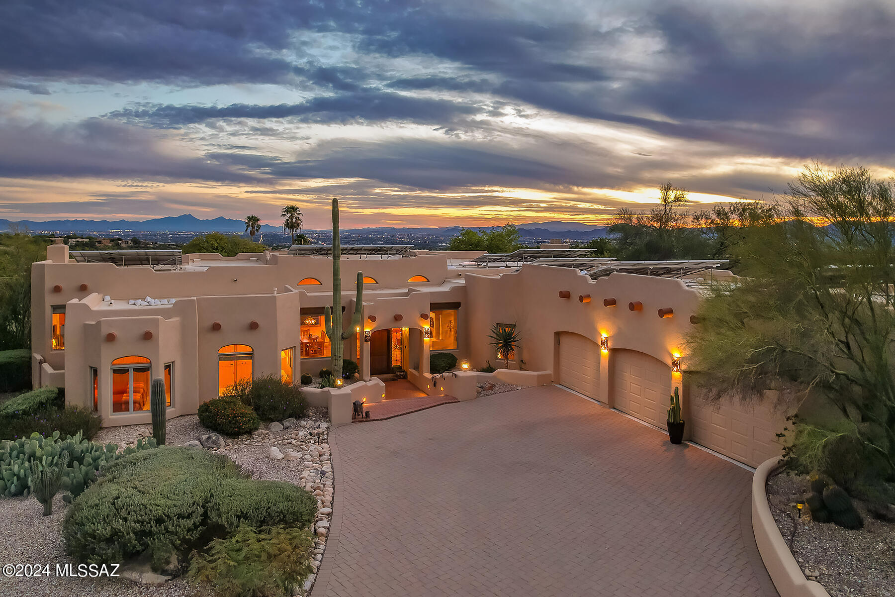 Nestled within the esteemed gated enclave of Sin Vacas, this exquisite 3,582 sq. ft. residence graces a prime corner lot, nearly an acre in size with a North/South exposure, and is adorned with breathtaking views of both the cityscape and surrounding mountains. This home presents a thoughtfully designed split bedroom layout, comprising four generously sized bedrooms and three well-appointed bathrooms. Adding to its versatility, one of the bedrooms currently serves as a sophisticated office, providing an ideal space for remote work or contemplative study.

At the heart of this home is the kitchen, a culinary haven equipped with top-tier stainless steel appliances and a central island, seamlessly blending functionality and style. This space opens into a welcoming family room, accentuated by a charming beehive fireplace, creating an ambiance of comfort and elegance. The home's open floor plan is amplified by soaring vaulted ceilings, bathing each room in an abundance of natural light. The expansive primary suite is a retreat unto itself, featuring a second beehive fireplace and direct access to the lush backyard.

The essence of outdoor living is captured in the home's exterior offerings, which include a vast covered patio and a delightful pool, creating a sanctuary perfect for relaxation and social engagements. Conveniently, one of the bathrooms provides direct access to the backyard, serving as an ideal pool bath.

Further enhancing this remarkable home are practical amenities such as abundant garage storage and energy-efficient solar panels. This Sin Vacas abode harmoniously blends comfort, sophistication, and practicality, making it an alluring choice for a diverse array of lifestyles.