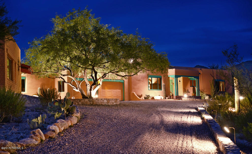 TRULY ENJOY THE TUCSON LIFESTYLE! This move-in ready Santa Fe is surrounded by 3.2 mountain-view acres. Meticulously maintained and completely updated, it features 4 fireplaces, nichos, viga beams, latillas shutters and cabinet doors, hand-carved corbels, and Mexican tile. The property consists of a 2 BR main house plus a charming 1 BR guest house. Classic finishes merge with modern elements such as stainless Bosch appliances and open concept living/dining area. Perfect for entertaining! Built by a well-known Tucson furniture maker, quality is evident with custom alder doors, cabinets and spacious closets. Polished concrete and easy-care saltillo tile floors throughout. Huge artist's studio is suitable for sculpting, wood-working, painting...anything! It includes 220 elec., workbenches vice, plentiful windows and lighting. It is pre-fit and designed for conversion into a luxurious master suite someday. Preliminary building plans are available.