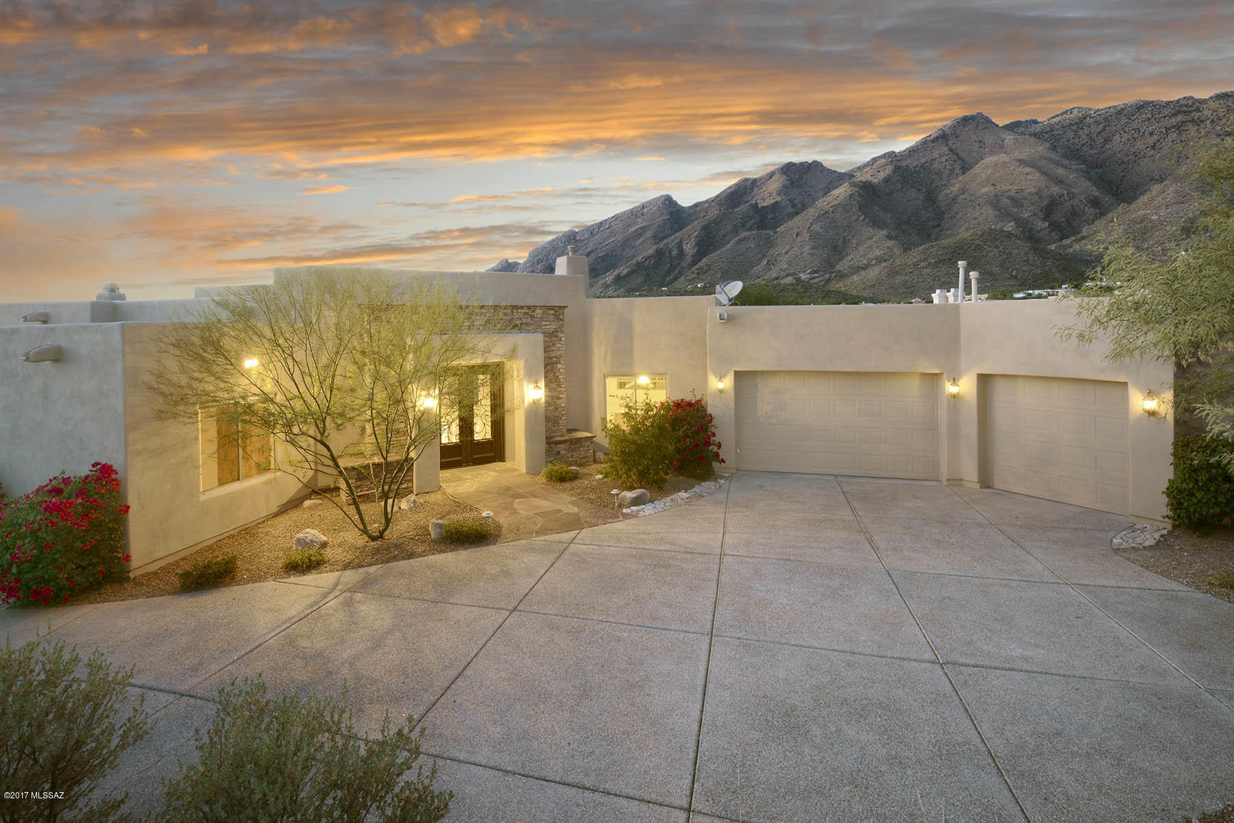 Custom Alta Vista home by local builder Gene DeVitis offers sweeping views of the Catalina Mountains & twinkling city lights. Beautiful iron doors welcome you into the large foyer & great room with walls of windows, wood beam ceilings & grand fireplace. Spacious cook's kitchen has butlers area, island with cook top, double ovens, many alder cabinets & granite counters. Kitchen opens to family room with stacked stone fireplace & built-in entertainment center. Luxurious master suite features cozy fireplace, steam shower & large walk-in closet. Guest rooms are en-suite & den with built-in cabinets. Entertain friends & family outdoors on the wrap around patio or by the sparkling pool, spa & waterfall with lush landscaping. 
**Seller is a licensed agent in Washington