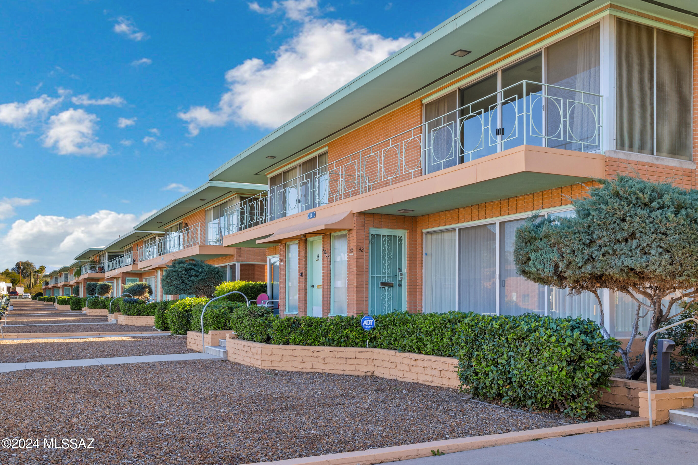 Villa Catalina in the historic Sam Hughes area; a 55+ community in the heart of Tucson! Enjoy mid-century modern garden architecture in 2bd/2ba spacious floor plan w/walls of windows leading to dual balconies for indoor-outdoor living.  North provides a GORGEOUS VIEW of the Catalinas & south a view of  pool & lush green grass & trees.  HOA takes care of everything outside the walls: ext. bldg maintenance, electric, water, sewer, trash, HVAC, water heater, landscaping, pest, 2 pools (1 heated), & even property taxes! Enjoy shuffleboard, BBQ area, putting green, 2 laundry rms & half of a 2-car garage.  Near UofA, Whole Foods, Himmel Park & many restaurants. Home retains much of its original charm & awaits a new owner to love! Officially listed on the National Registrar of Historic Places.