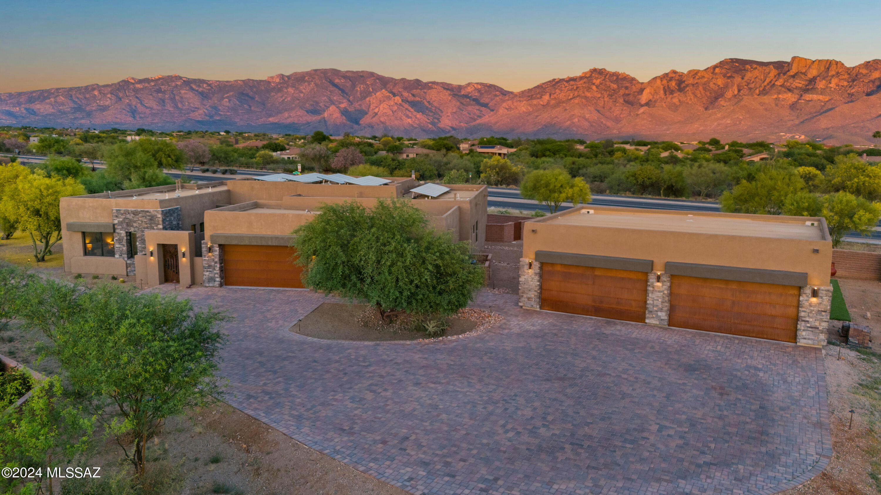 Discover the serene beauty of the desert landscape as you approach this stunning, semi-custom home in the coveted La Canada Ridge community. Enter through the private courtyard and into the foyer to be captivated by sweeping views of the Catalina mountains! This split bedroom, open floorplan home offers spacious bedrooms and living areas as it seamlessly blends luxury and practicality. The gourmet kitchen boasts satin marble countertops and top-of-the-line Dacor appliances. Enjoy the hidden value of owned solar, comprehensive air and water filtration systems, and smart home features like wifi-enabled blinds and pool equipment. Imagine the endless possibilities with a 1200 sq ft, 4-car detached garage! Don't miss this rare opportunity to make this exceptional home yours!