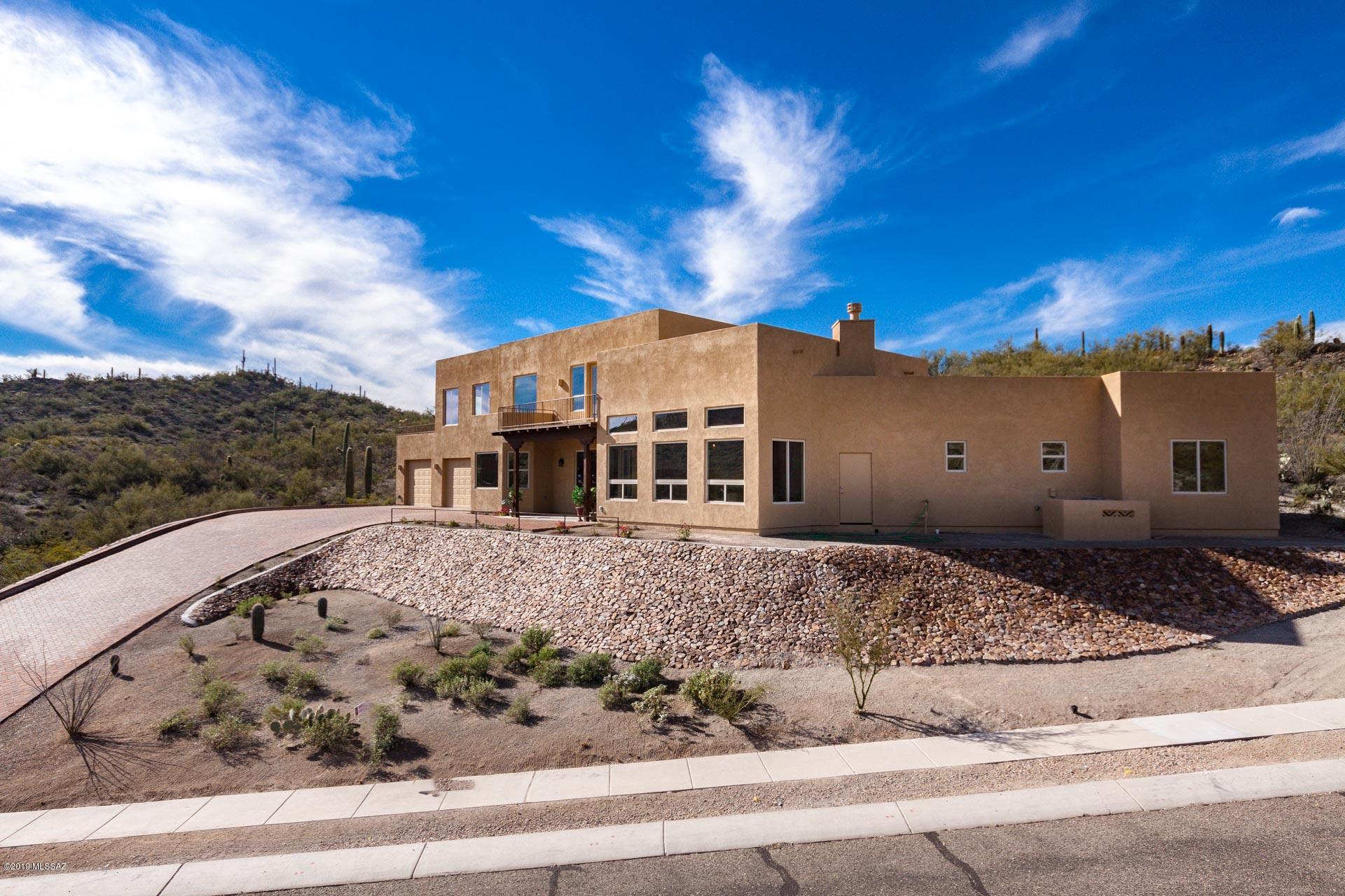 Luxurious & Contemporary NEW Custom Home in gated community at Starr Pass & Arnold Palmer Signature golf,three car garage,inviting entry featuring High Ceilings with exposed beams at G. Room, stunning views from breakfast nook,great open kitchen with custom built 42'' Alder cabinets with soft close drawers,GE profile appliances, gas cook top, granite counters,island, walk in pantry,30'' built in Microwave/convec. wall oven,instant hot water dispenser.Retreat leading to upstairs to an open loft/office GREAT Mont views extra bedrm upstairs, great hall going to a Master Suite with picture windows and city views, private deck to enjoy peaceful mountain views.Huge walk in closet with w/d closet within.Enjoy luxurious walk in shower italian tile at The master bath and double sinks.Wide driveway