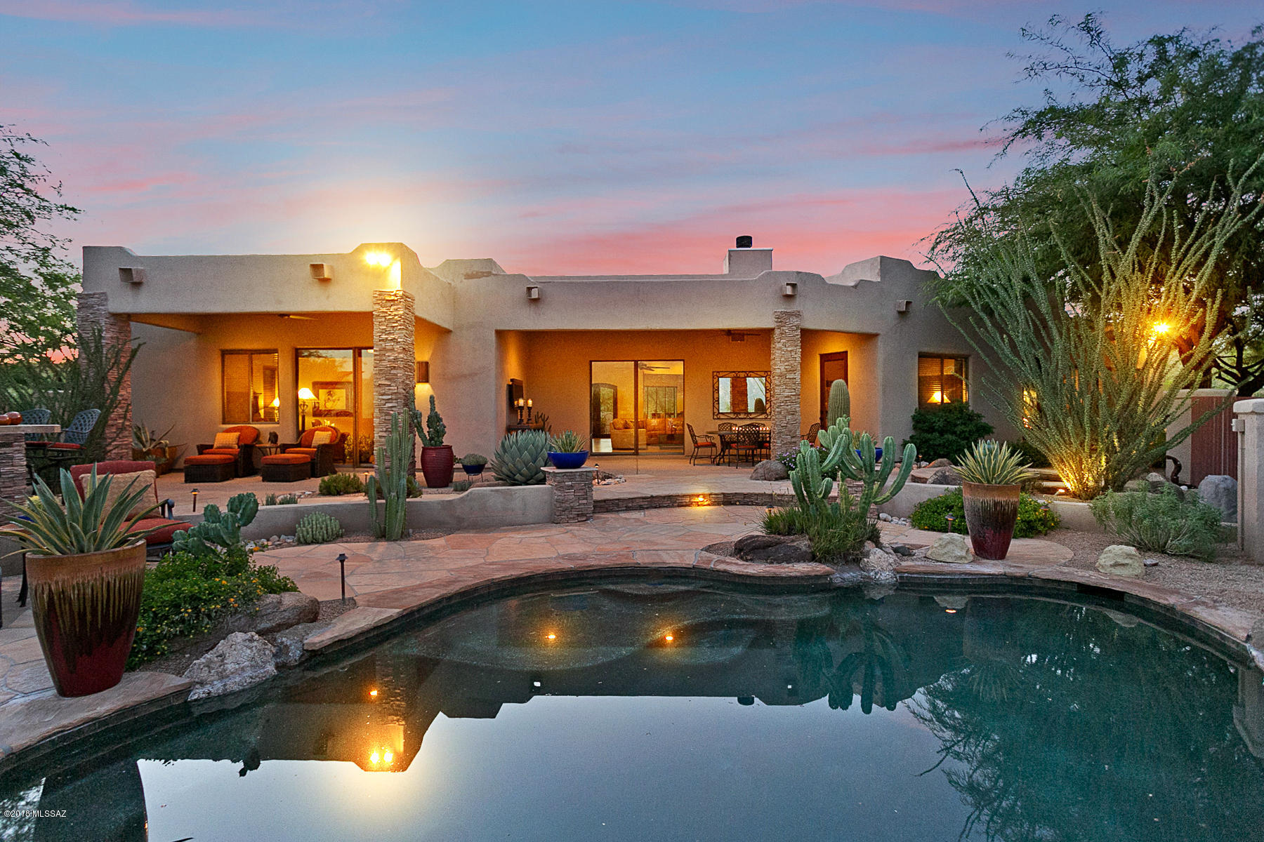 This spectacular custom home has sweeping views of the Catalina Mountain Range. From the moment you enter the glass entrance doors you enter a world of breathtaking luxury. No expense has been spared or amenity overlooked. Open floor plan with views from every room. Dream gourmet kitchen with professional SS appliances, granite counters and separate wine cellar. The large Great Room boasts a custom fireplace, large TV and looks through a wall of glass out to the pool and entertaining area. The adjoining 1.71 AC Vacant Land Parcel 305-50-003E (MLS 21820947) shall be sold with and included in the purchase transaction of this Land Parcel 305-50-003D creating a 3.2 AC estate of privacy and views.