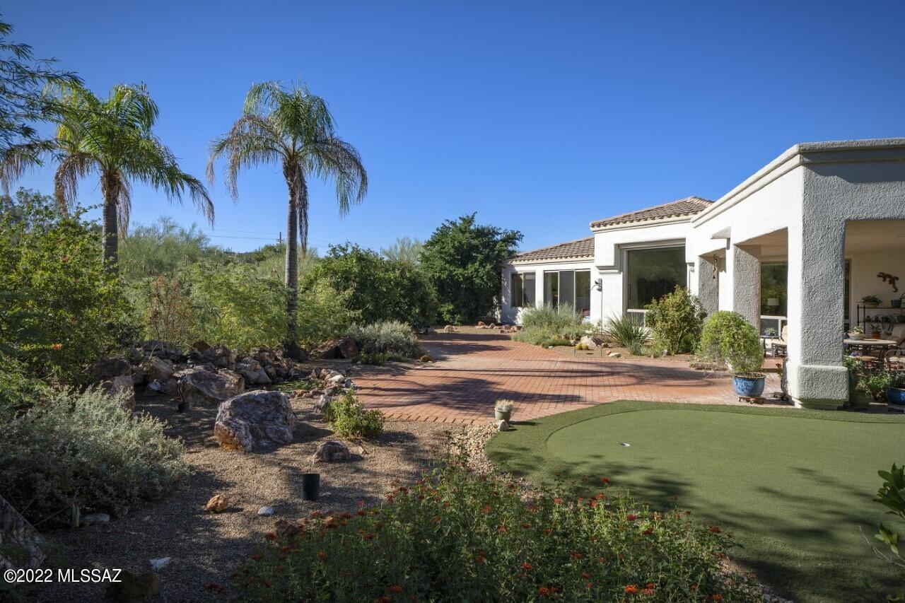 This lovely 4 bedroom 2.5 bath home features spectacular views of Pusch Ridge and Catalina mountain range. . Relax in your own private back yard with covered patio while enjoying the views and listening to the waterfall cascading into the pond.  Enjoy putting in your own backyard. The house offers a split bedroom floor plan. The master bedroom suite contains a sitting area, walk in closet and primary bath featuring a garden tub and walk in shower. Once bedroom is currently setup as a home office utilizing modular components including file storage in the closet that can easily be converted back to a bedroom. The Kitchen and Family Room is an open concept with double ovens, pantry and cozy fireplace. The water heaters and both of the HVAC systems were replaced in 2022,
