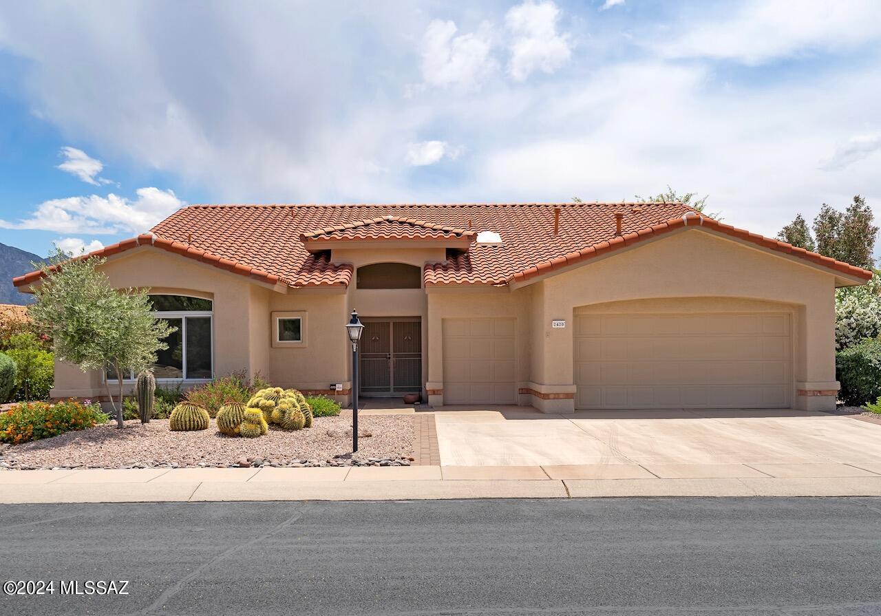 With mountain views and a myriad of upgrades, this (modified) Carrington floorplan in Sun City Oro Valley is a fantastic find. Situated beautifully within the neighborhood, and offering a third garage bay for your golf cart or hobby, it is poised to immerse you in the best of community living. Tile and wood look floors throughout (no carpet), wood cabinetry, and sophisticated neutral finishes make this spacious home an incredible opportunity without compromise. From the high ceilings, to the stainless appliances, this property was stylishly designed and lovingly maintained. The primary suite has an expansive bay window, walk-in closet, door to the patio, and stunningly remodeled bathroom. An additional bedroom with en-suite bathroom is ideal for guests or as a second owner's suite. The third bedroom is currently an office with built in bookshelves. Copious storage, updated systems, and an oversized back yard, all just a short distance to community center, restaurant, activity center, tennis, pickleball, heated pools, golf, bowling, and a fabulous gift shop (for just small annual fee).